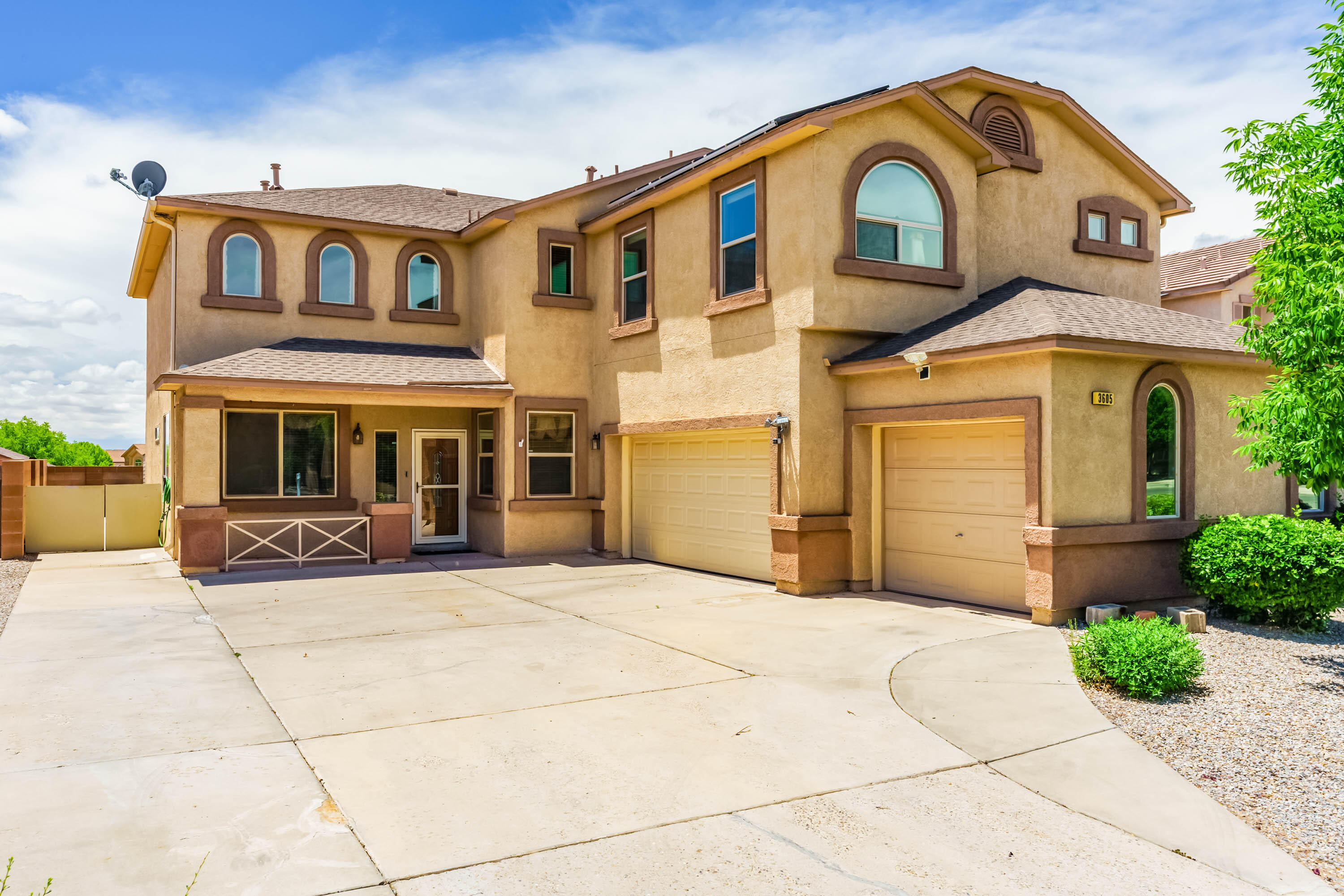 With over 3100 square feet of space, this 5 bedroom, 3 FULL bath home is ready for its new owner.  Do you want 2 refrigerated air units? CHECK!  Do you want solar panels where PNM pays you between $200-$250 a quarter?  CHECK!  Do you want a central vacuuming system?  CHECK!  Do you want a 3-car garage?  CHECK!  Do you want a downstairs bedroom and bathroom separate from the upstairs bedrooms?  CHECK!  Do you want cathedral ceilings?  CHECK!  How about wiring for surround sound?  CHECK! This home has a water softener system, custom blinds, a custom fireplace in the living room, and Cardell cabinetry in the kitchen.  Appliances are all Samsung brand.  The pergola in the backyard was custom made at a cost of $6000. It's nice!  Come ''check'' it out today to see if this is your new home!