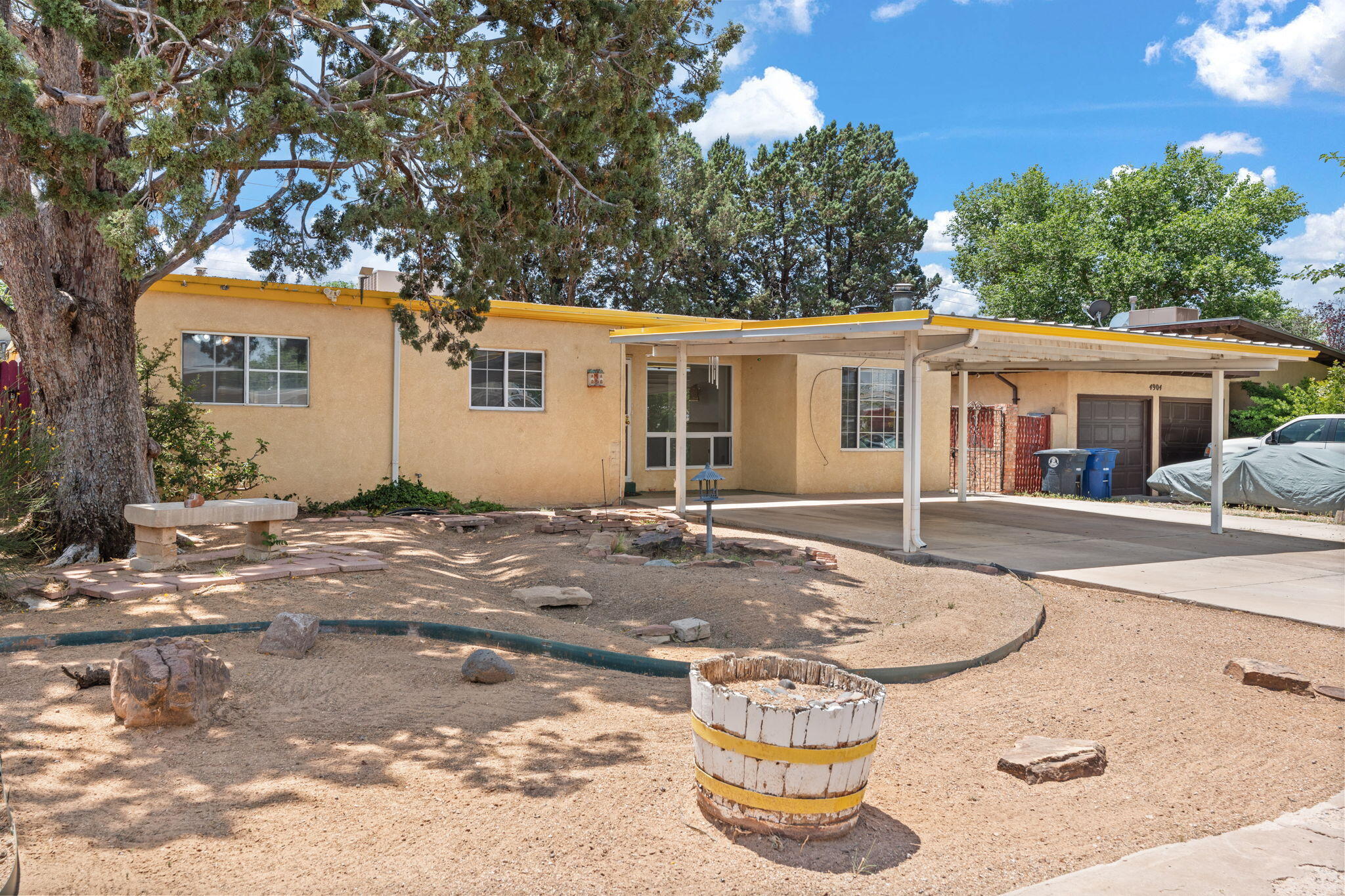 Welcome to this well-loved home, cherished by the same family for many years! Step inside to find two spacious living areas perfect for hosting movie nights or holiday gatherings. The large kitchen offers plenty of room to cook and connect. Outside, enjoy fun-filled afternoons on the basketball court or relax under the covered patio--ideal for BBQs and summer get-togethers. The generous carport provides ample parking. With easy access to the Paseo Del Nordeste Bike Trail and just half a mile from Lovelace Women's Hospital, this home offers both comfort and convenience close to schools and parks.