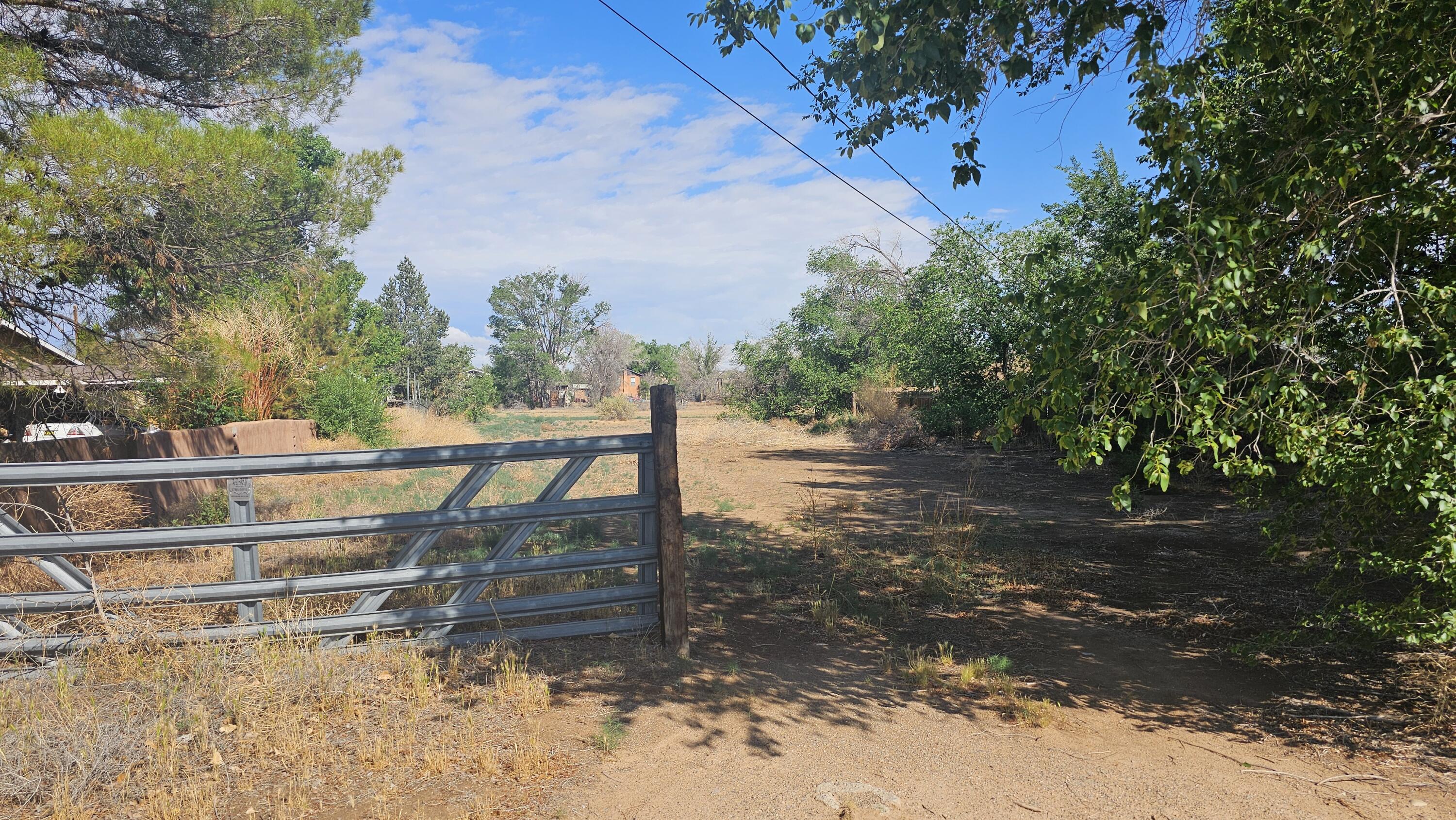 Beautiful parcel of Corrales Green Belt land ready for your New Home Vision bordering the mid-acequia. Nice views, privacy with front door access to miles and miles of trails! Bring your horses! Corrales is the Horse Capital of NM, has the 'Safest Cities Designation' in NM, plus a myriad of paths, mountain vistas, in town country, rich history: Money Magazine Voted Corrales as one of 20 best places to live in the United States. Great shops, restaurants, brews, recreation; Village Pizza, Ex Novo, Mulas, Etcetera Consignment,  Casa Vieja Tasting, Hannah and Nates, Indigo Crow, Perea's, Sandia Bar, Flying Star, Sprouts, Rec Center Pool, Horse Arena, Fishing Pond, Skate Park, Tennis, Basketball, PIckleball, Soccer fields, Growers Market. Straw Bale USPS,Cottonwood Mall 10 min, Airport 30 mins