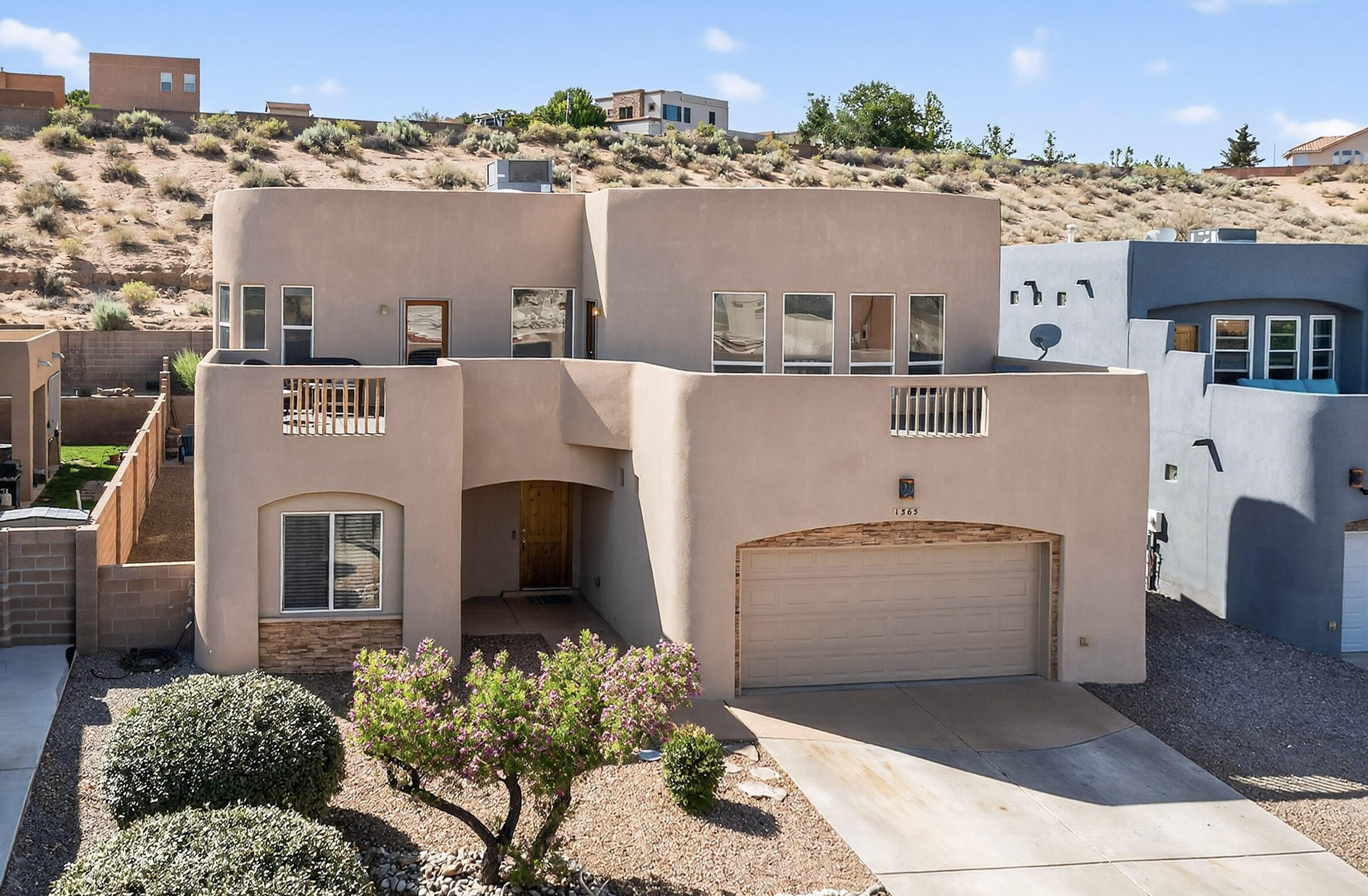 Perched on the western edge of the Rio Grande Valley in Trinity Estates, this 2004 Corinthian Construction home is full of natural light, Southwest charm, and thoughtful updates. A vaulted beam ceiling with large windows and tons of natural light, highlights the main living space that flows into a spacious kitchen and dining area. There are four inviting bedrooms, including two joined by a Jack-and-Jill bath. Upstairs, the second living space and primary suite offer balcony access and stunning views of the Sandias and Manzanos. Recent upgrades include a new roof, HVAC system, and updated floors and paint throughout, ensuring modern comfort and style. Thoughtful Southwest finishes add warmth and character to this turnkey home located in a prime area of Rio Rancho. This is a MUST SEE!