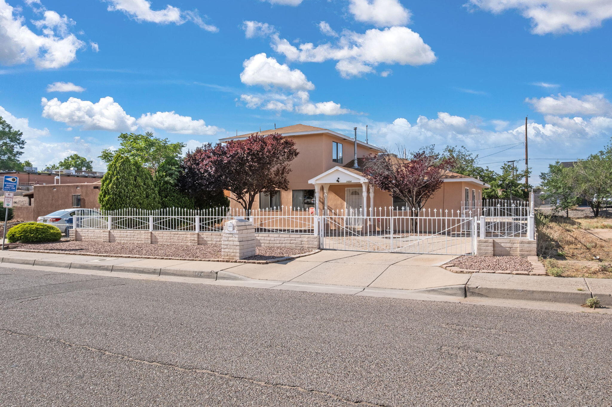 Just a short walk to UNM Athletics, the Pit, Isotopes Park, and great local restaurants, this spacious home puts you right in the heart of it all! Step into a bright living room with a unique glass block feature wall and enjoy the open feel throughout. The kitchen offers gas cooking and a central island--perfect for meal prep and gatherings. With large bedrooms, 2.5 baths, and a roomy laundry area, there's space for everyone. Out back, you'll love the low-maintenance turf yard and open patio for relaxing or entertaining. A gated driveway adds privacy and convenience in this unbeatable location!