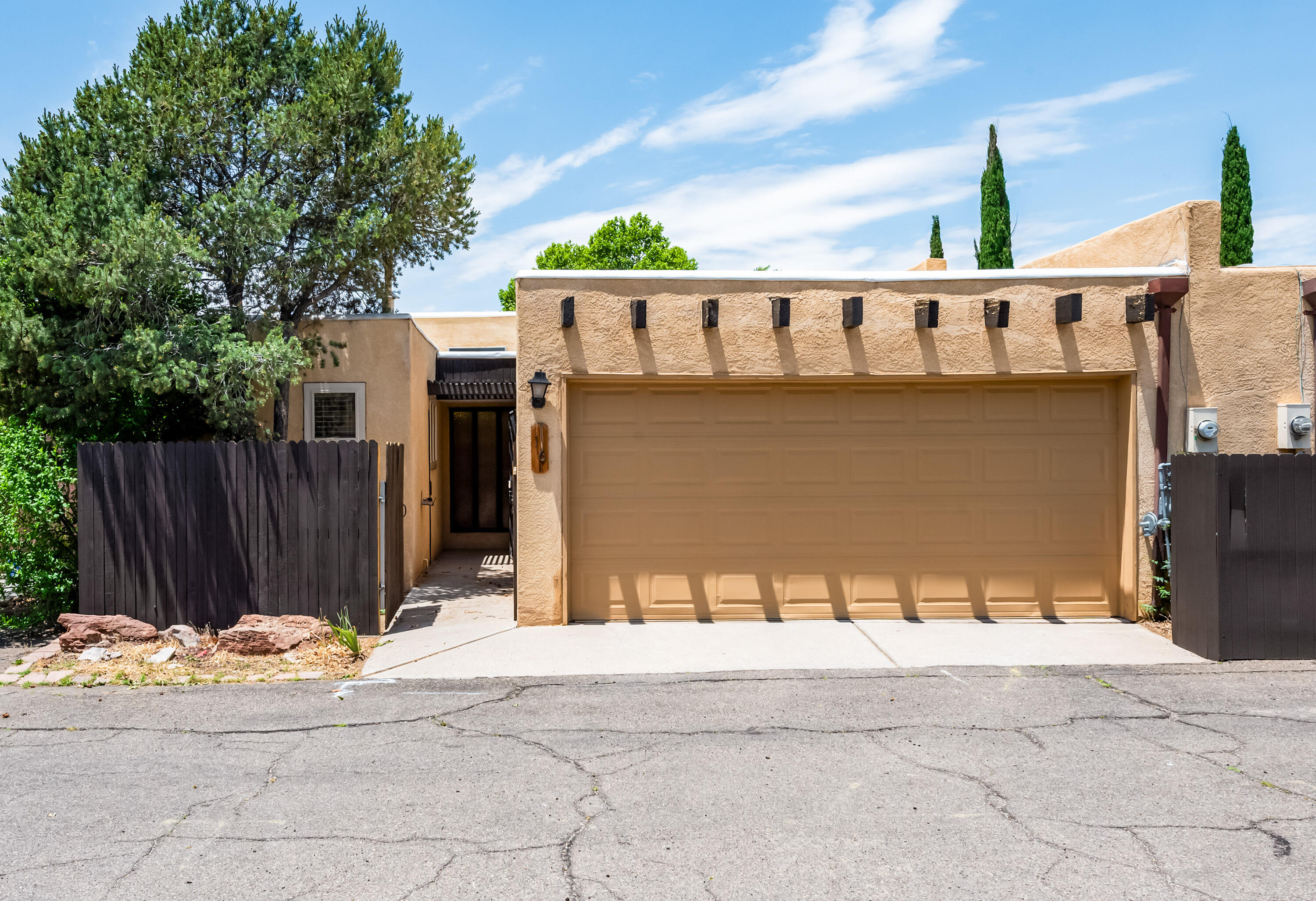 Nicely maintained one-story townhouse in Villa Encantada  with private courtyard entry, 3 bedrooms, 2 baths, and 2 car garage. Vaulted ceilings in spacious living area, with corner fireplace. Access to private fenced patio from both the living area and primary bedroom. All appliances convey. HOA covers well-maintained grounds, community center and swimming pool, as well as water and trash fees.