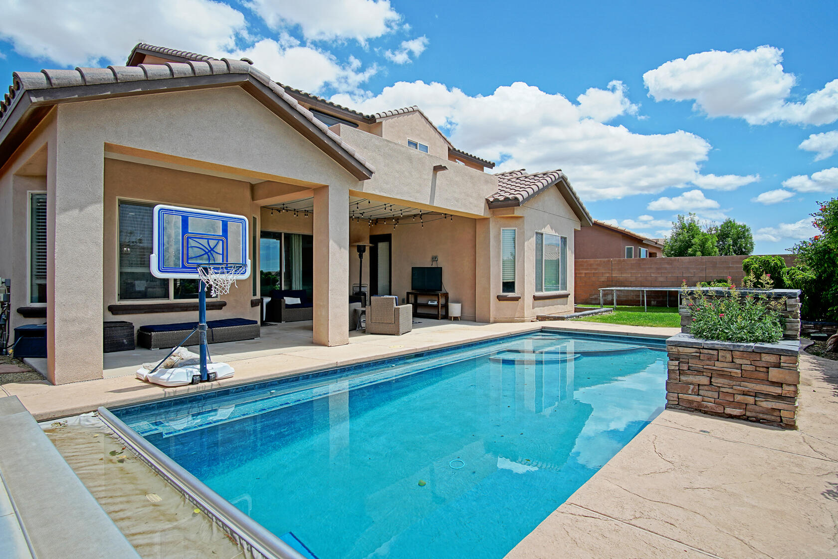 Stunning home with a pool in the exclusive gated Tres Colinas neighborhood.  Backyard oasis features a heated, in-ground gunite pool w automatic safety cover, gas stub-out for grilling, professional landscaping, & spacious covered back patio with expansive 14-foot 3-paneled glass sliding door.Inside, the beautifully updated kitchen is a chef's dream, showcasing white custom cabinets that extend up to 10ft ceilings, white quartz countertops, a large center island, & butler's pantry.  The office also features floor to ceiling cabinetry.  4-zone refrigerated air.Upstairs, a generous loft connects 2 bedrooms on each side.  One side w a Jack and Jill bathroom. Downstairs, a casita w full bath connects to a massive additional living area.Enjoy 2-toned synthetic stucco & courtyard entrance