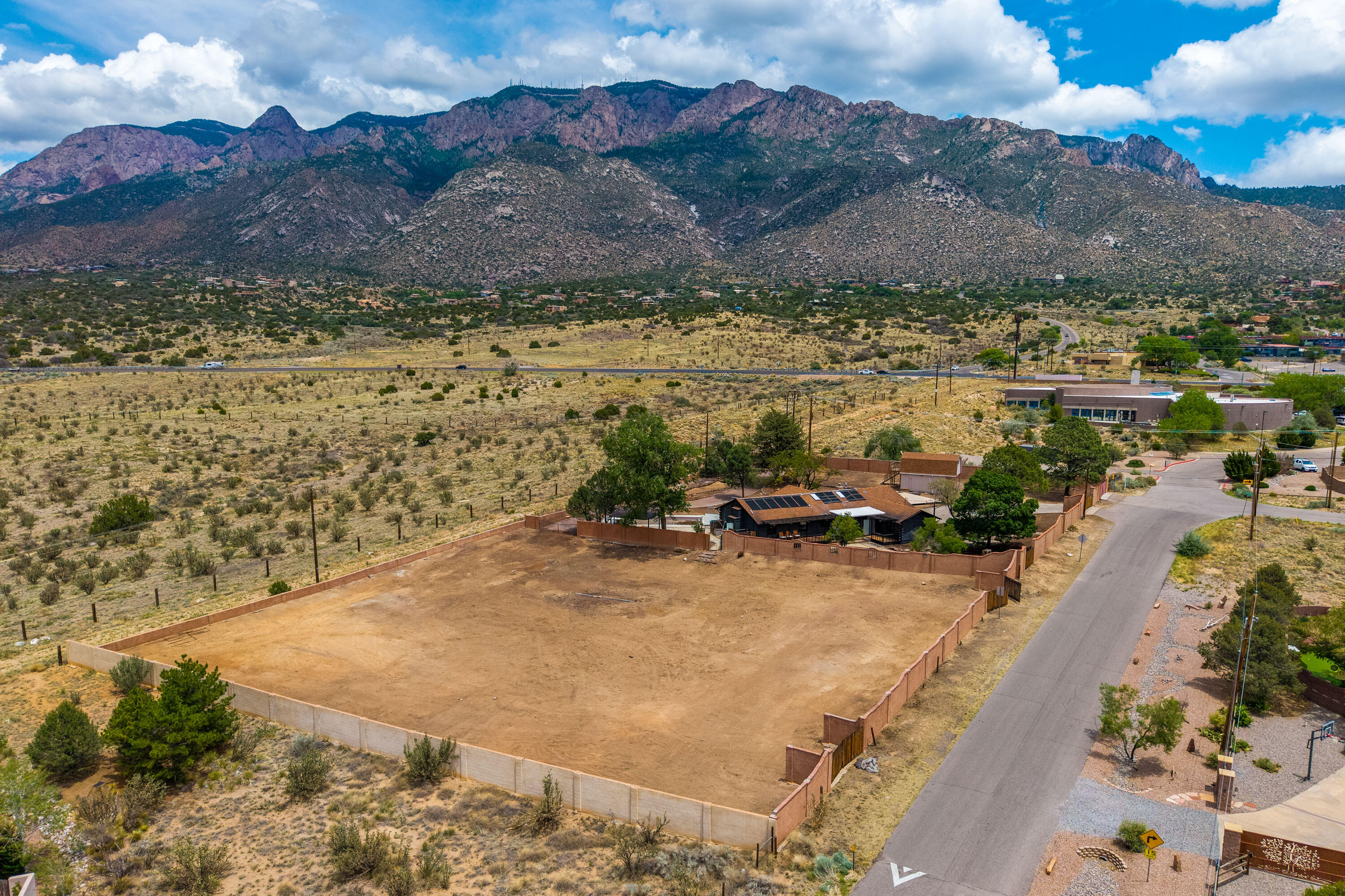 Rare opportunity on the North side of prestigious Elena Drive! These two already-subdivided lots, each .78 acres, total 1.56 acres and back directly to the Sandia Pueblo buffalo preserve, offering exceptional privacy and unobstructed views of the Sandia Mountains and Albuquerque city lights. One lot features an updated log home with 4 bedrooms, 3 baths, an open kitchen, and a spacious living area with a cozy fireplace--making conventional financing a breeze. The home has also been successfully used as a short-term rental, offering strong income potential. Live in the existing home while building your dream estate on the adjacent lot, or create a luxurious compound in one of North Albuquerque Acres' most coveted locations.