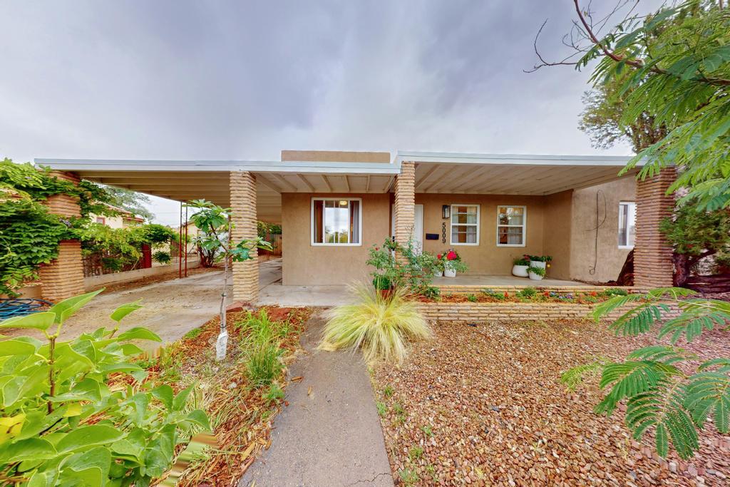 Nestled on a quiet North Valley street, 5009 El Paseo is a bright and charming retreat. Flowering shrubs and a stunning wisteria welcome you home and offer privacy. Inside, you'll find cove ceilings, rounded archways, and a versatile floor plan. A spacious living room with floor-to-ceiling built-ins and large windows gives you a picturesque view of the patio and garden. The galley kitchen flanked by two rooms offers endless possibilities. The spacious laundry room, primary bedroom, and storage room give you ample opportunity to make this gem your dream home. Enjoy peace-of-mind with an updated TPO roof March 2025) and MasterCool(June 2025). Minutes from some of the best trails, coffee shops, and restaurants the North Valley has to offer. Don't miss this opportunity to make it yours!