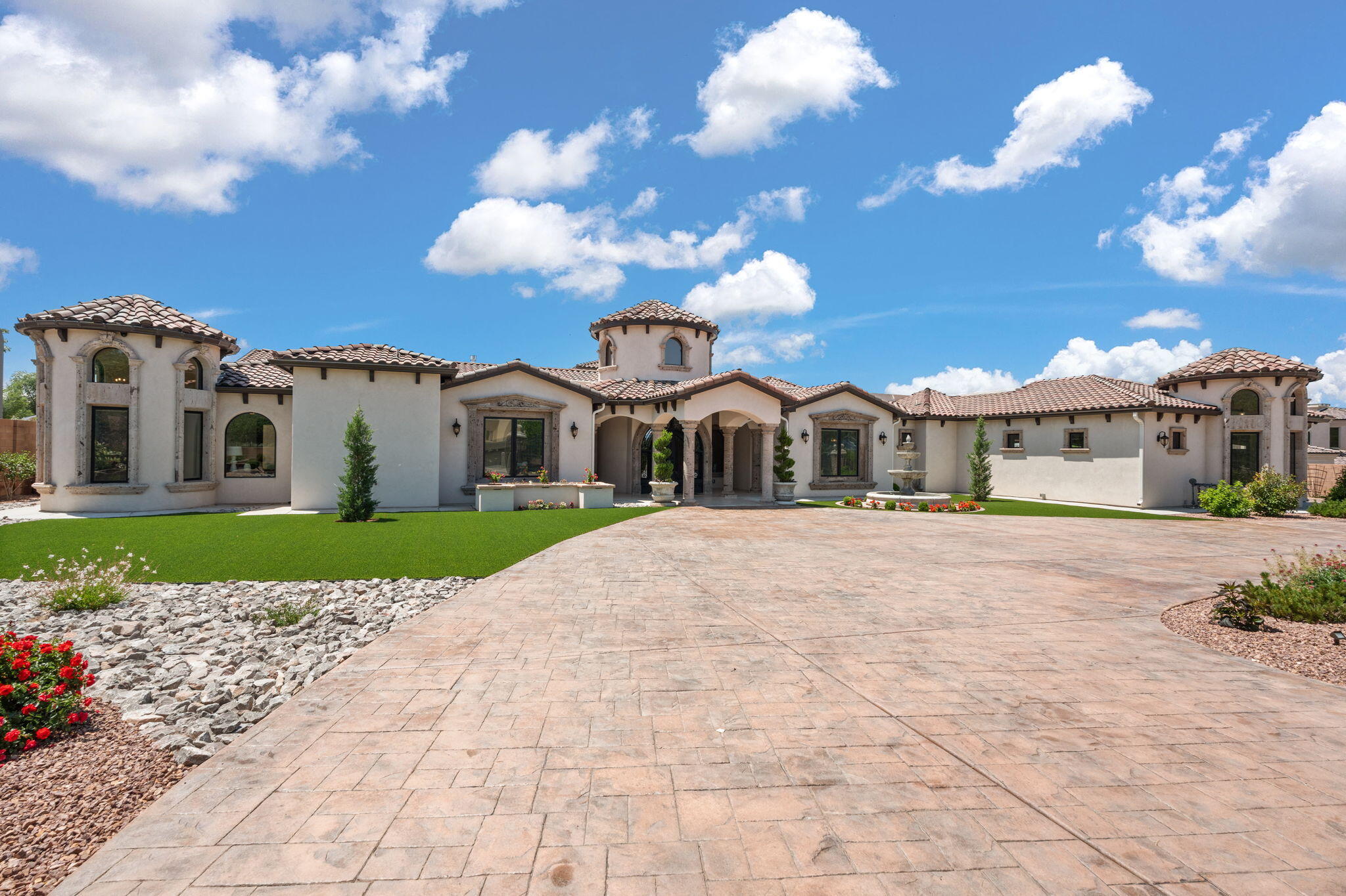 Welcome to a breathtaking Tuscan-modern estate where timeless elegance meets contemporary sophistication. Spanning 5,695 sqft, this architectural gem was crafted with meticulous attention to detail and no expense spared, offering a seamless blend of old-world charm and modern luxury in one of the most coveted areas of Albuquerque. Every inch of this home reflects masterful design--from the grand arched entryways and exposed wood beams to imported cantera stone finishes and expansive windows that flood the interiors with natural light. The flowing open-concept layout is ideal for both refined entertaining and comfortable everyday living. At the heart of the home lies a gourmet chef's kitchen, complete with a massive center island, granite countertops, top-of-the-line Thermador