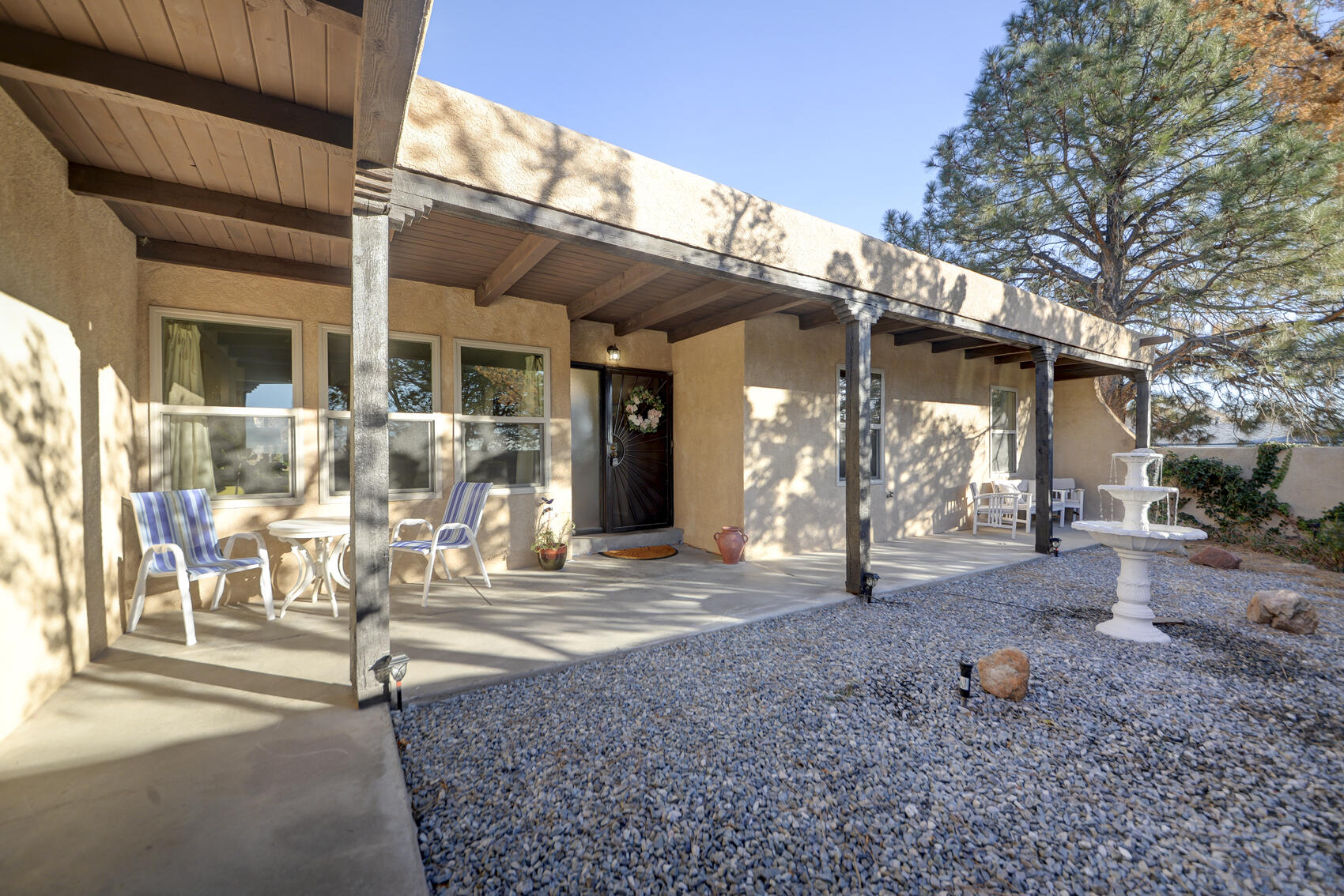 Southwestern character with elegant, modern finishes.Step inside to find A light filled open floor plan with saltillo tile, wood-beamed ceilings, and a kiva fireplace in the cozy living area A remodeled chef's kitchen with granite countertops, stainless steel appliances, custom cabinets, and a charming breakfast nook A spacious primary suite with private bath and generous closet space, updated bathrooms with tasteful modern touches newer windows throughout for efficiency and natural light fresh interior paint and new flooring throughout. Enjoy peaceful outdoor living in the private gated courtyard with a fountain, or relax under the covered back patio ideal for entertaining or soaking in the New Mexico sunset.