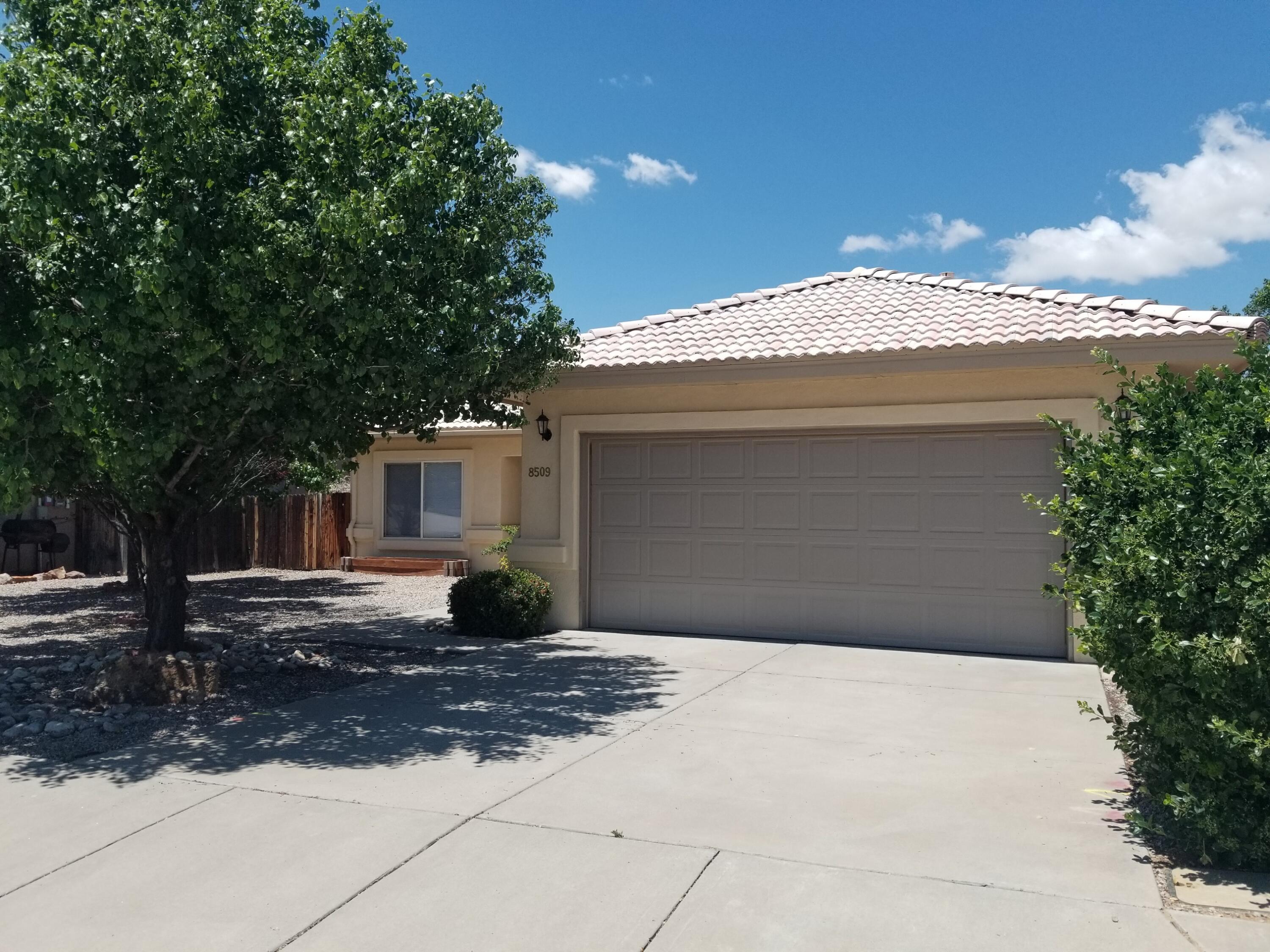 Beautifully Maintained Home close to Shopping, Freeway and Domingo Baca Park  Single Story Open Floor Plan with Tile and Wood Laminate Flooring ''No Carpet'' and attractive vaulted ceilings. Refrigerated Air, Granite Kitchen Counter Tops installed 2021 and in 2025 a new Refrigerator and Washer Dryer were replaced also in 2025 the Garage Door System and Motor were replaced. In 2023 the Stucco was repainted with Masonary Paint.  In 2023 the Back Patio Roof was replaced. This Large Covered Patio plus the Mature Trees create a Cool Shaded Location especially for Summer Entertaining. Come on by Today, you'll want to Make This Home to be Yours.