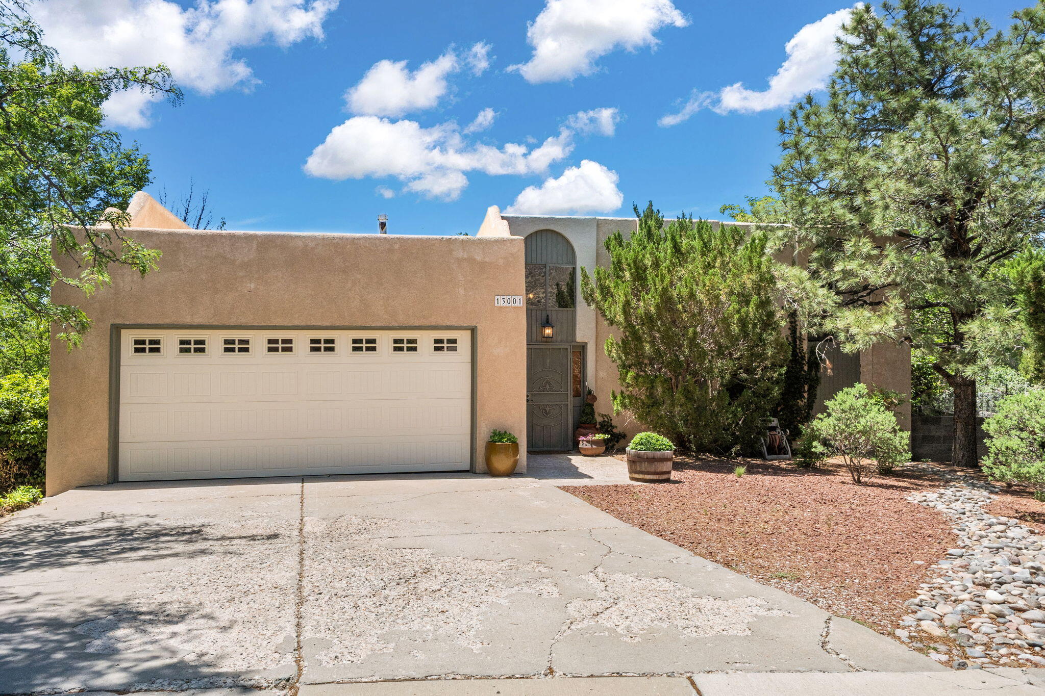 Glenwood Hills gem! Tucked away in an established neighborhood at the end of a cul-de-sac, this property boasts true NE Heights living! Located in the foothills of ABQ and close to everything you could need. With 5 bedrooms, 3 bathrooms and 2 large living areas, this home has tons of space. Walk out to the massive deck, overlooking the large, beautiful back yard full of lush grass, fruit trees, dog run area and back yard access for your toys or trailers. The backyard gate allows quick access to tennis courts, pools and gym facilities. Downstairs includes 2 bedrooms and it's own living space. Mountain views from the front add to the beauty. This property feels like home and is full of natural light. A great property with tons of character in a desirable location. This is a must see!