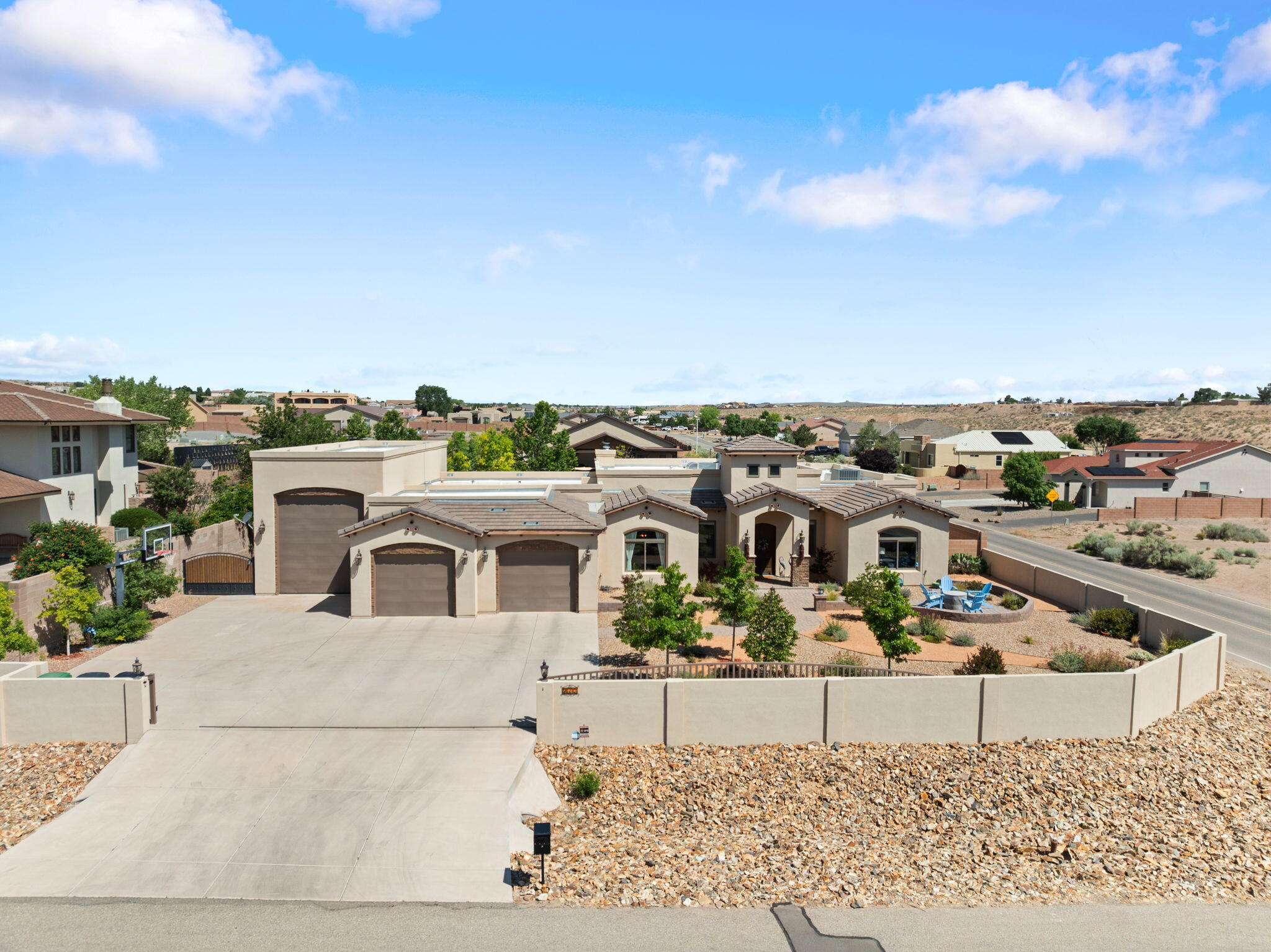 This exceptional custom home features a fully insulated 54 X 16 ft attached RV garage in addition to an oversized 2 car garage with a workshop area - this is just the start of what makes this a truly unique find.  Situated on a 1/2 lot with an automatic gates the home is fully landscaped. Excellent layout - featuring 2 Bedroom suites, and a second living area with access to the backyard, excellent kitchen with 2 dishwasher- elegant dining room taking fully advantage of the incredible views of the Sandias. The backyard is an oasis with a covered back patio with a custom wood-burning fireplace.. The owner has continued to improve the home - since 2021 the following updates have taken place;; added storage shed and cement pad,  California closets, extended back wall and side wall,