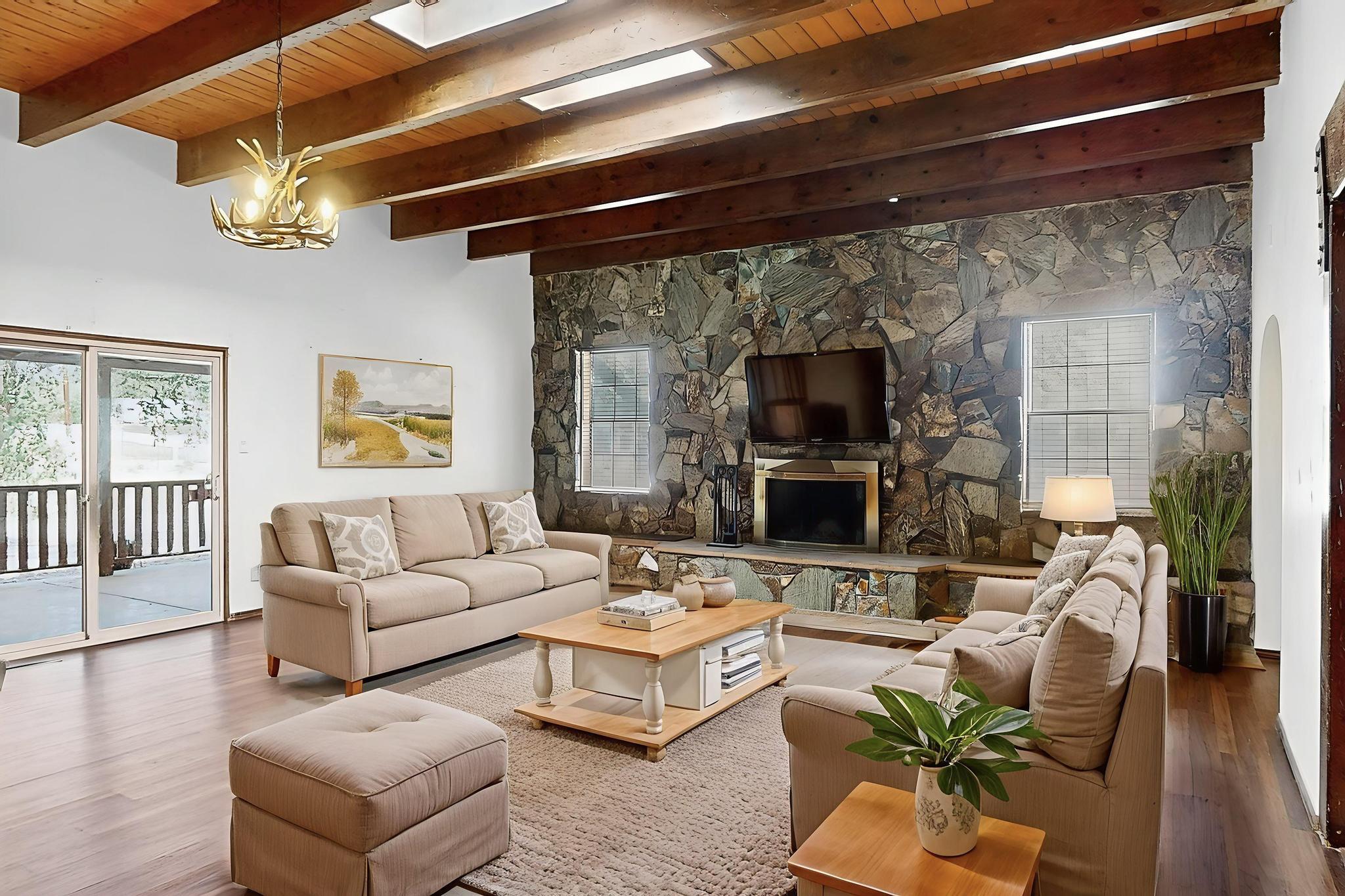 Beautiful 3-bedroom, 2-bath home set on over half an acre in a desirable corner lot location. A bonus room offers flexibility as a home office, craft room, or quiet retreat.The expansive family room is a showstopper, featuring dramatic beam ceilings and a stunning full-wall stone fireplace. The generous primary suite offers its own cozy kiva fireplace, creating a warm and inviting atmosphere.Enjoy outdoor living with a charming front patio and pergola, an extended covered patio out back, and full backyard access. The fully fenced backyard includes new chain link fencing.Recent updates include new luxury vinyl plank (LVP) flooring, new garage doors, and two new gas furnaces. The attached 2-car garage provides convenience and extra storage.
