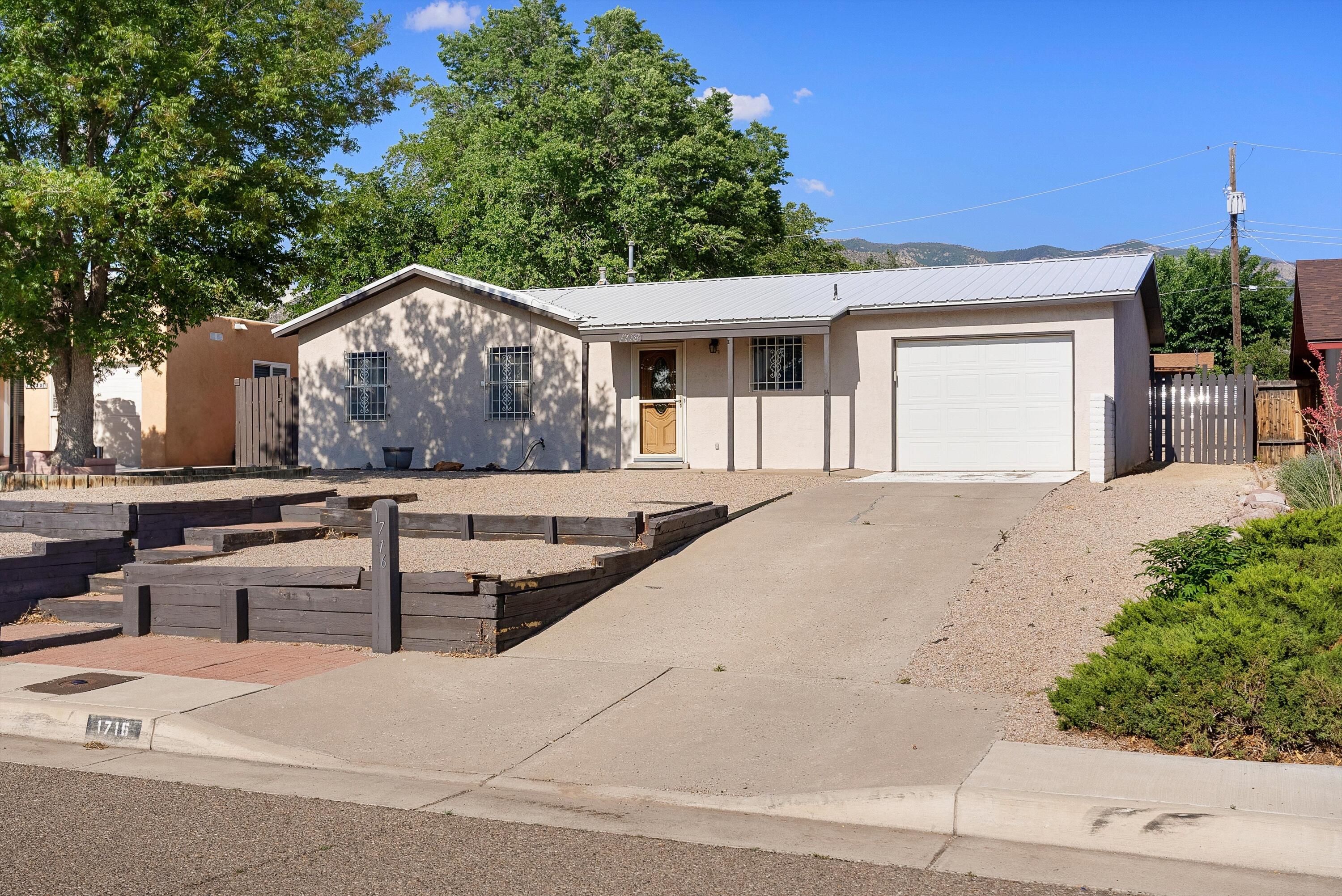 Don't miss this move-in ready 3-bedroom, 2-bath home in the highly sought-after Northeast Heights of Albuquerque! This charming home features newer vinyl flooring and remodeled bathrooms with modern finishes. The spacious living area is perfect for entertaining or relaxing with family.Enjoy breathtaking Sandia Mountain views from the private backyard--ideal for outdoor gatherings or peaceful mornings. Located in a quiet neighborhood close to parks, schools, shopping, and dining.This home offers comfort, convenience, and the upgrades you've been looking for. Schedule your showing today!