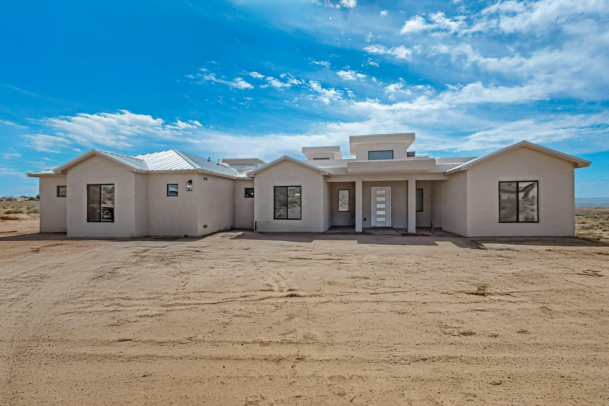 Welcome to modern Southwest living in this beautifully designed home on 1.4 acres with panoramic mountain views. Featuring an open floor plan that maximizes natural light and outdoor space, highlighted by an oversized sliding glass door opening to the covered patio--perfect for entertaining or relaxing under New Mexico skies. Step inside to find NuCore(r) Performance luxury vinyl plank flooring throughout the main living areas--GreenGuard Gold Certified. The home also showcases gorgeous quartz countertops throughout, adding an elegant, timeless finish to every space. The kitchen is an entertainer's dream come true, offering an oversized island for prep space, and a walk-in butler's pantry for added storage and organization- ideal for both everyday living and entertaining. The primary suite is