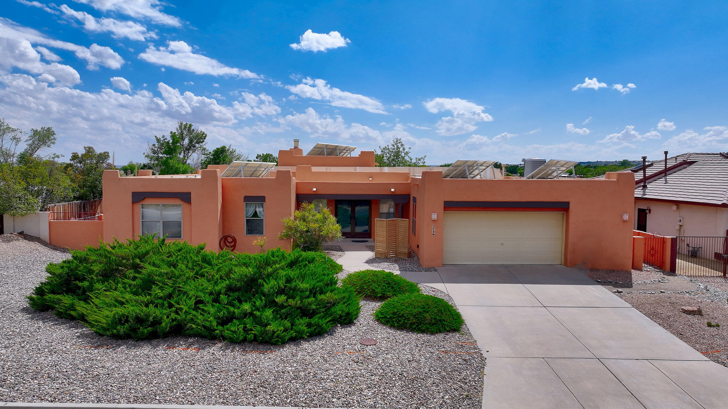 Discover this charming 3 bed, 2 bath home nestled in Rio Rancho. The open-concept design offers a seamless flow from the modern remodeled kitchen, featuring granite countertops & stainless steel appliances, to the inviting living room, where a kiva fireplace serves as a centerpiece. Enjoy abundant natural light & a finished sunroom that leads to a landscaped backyard, perfect for outdoor relaxation. The oversized 2 car garage w/ a workshop area provides ample storage, while newly painted exteriors & updated windows enhance curb appeal. With owned solar panels for energy savings, hard surface flooring throughout, & new storm doors for added insulation, this property is ready for you to call home. Watch stunning sunsets & hot air balloons from the patio, all while backing onto open space!