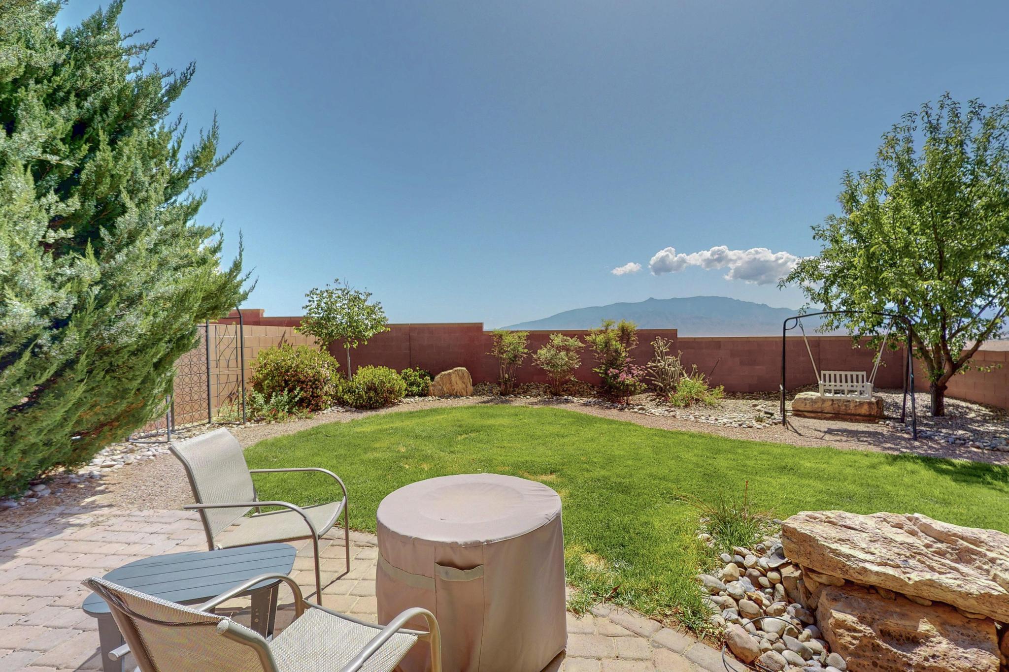Rare opportunity in Loma Colorado - premium lot with unmatched Sandia Mountain Views. Discover one of the most sought-after locations in all of Loma Colorado--one of only three homes offering unobstructed views of the Sandia Mountains with tranquil open space directly behind. This beautifully maintained 3-bedroom, 2.5-bath home is packed with upgrades, energy-efficient features, and exceptional outdoor living. Step into your own private oasis with a fully landscaped backyard featuring a paver patio, water feature, mature trees, and a lush real grass lawn. Enjoy seasonal harvests from an apple tree and concord grape vine, all supported by a full 4-zone irrigation system. Inside, you'll find upgraded tile flooring with mosaic detail at the entry, a modern kitchen with granite countertops,