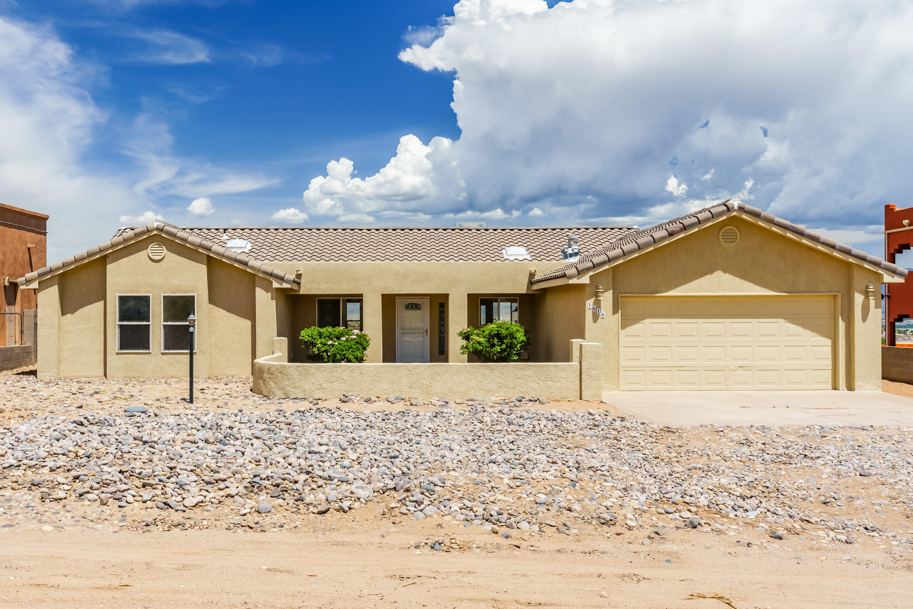 Welcome home! This stunningly renovated home on a 0.5-acre lot has unobstructed Sandia Mountain views! This 3-bedroom, 2-bath plus flex room beauty offers vaulted ceilings, fresh paint, a new furnace, a new water heater, updated fixtures, and a sleek kitchen with new counters and appliances. The spacious open layout is perfect for entertaining, anchored by a cozy fireplace. Retreat to the primary suite with a spa-like bath, dual vanities, a soaking tub, and a separate shower. Enjoy outdoor living on the extended covered patio with turf lawn and fire pit. Quiet street, big views, and room to breathe! Schedule a tour today!