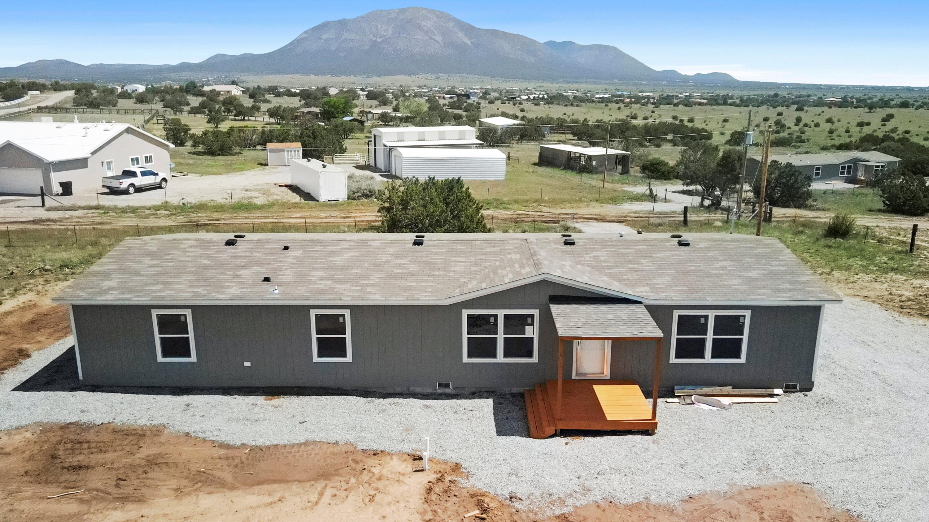 This brand-new, never-lived-in home in the East Mountains of Edgewood, NM sits on an expansive 2.5-acre lot--ideal for gatherings or your furry and feathered friends. The open floor plan includes two spacious living areas and a split primary layout for added privacy. Enjoy modern comfort with refrigerated air and the convenience of all appliances conveying. Three of the four bedrooms offer walk-in closets, providing ample storage. Don't miss this thoughtfully designed home that blends comfort, space, and privacy in a peaceful mountain setting.