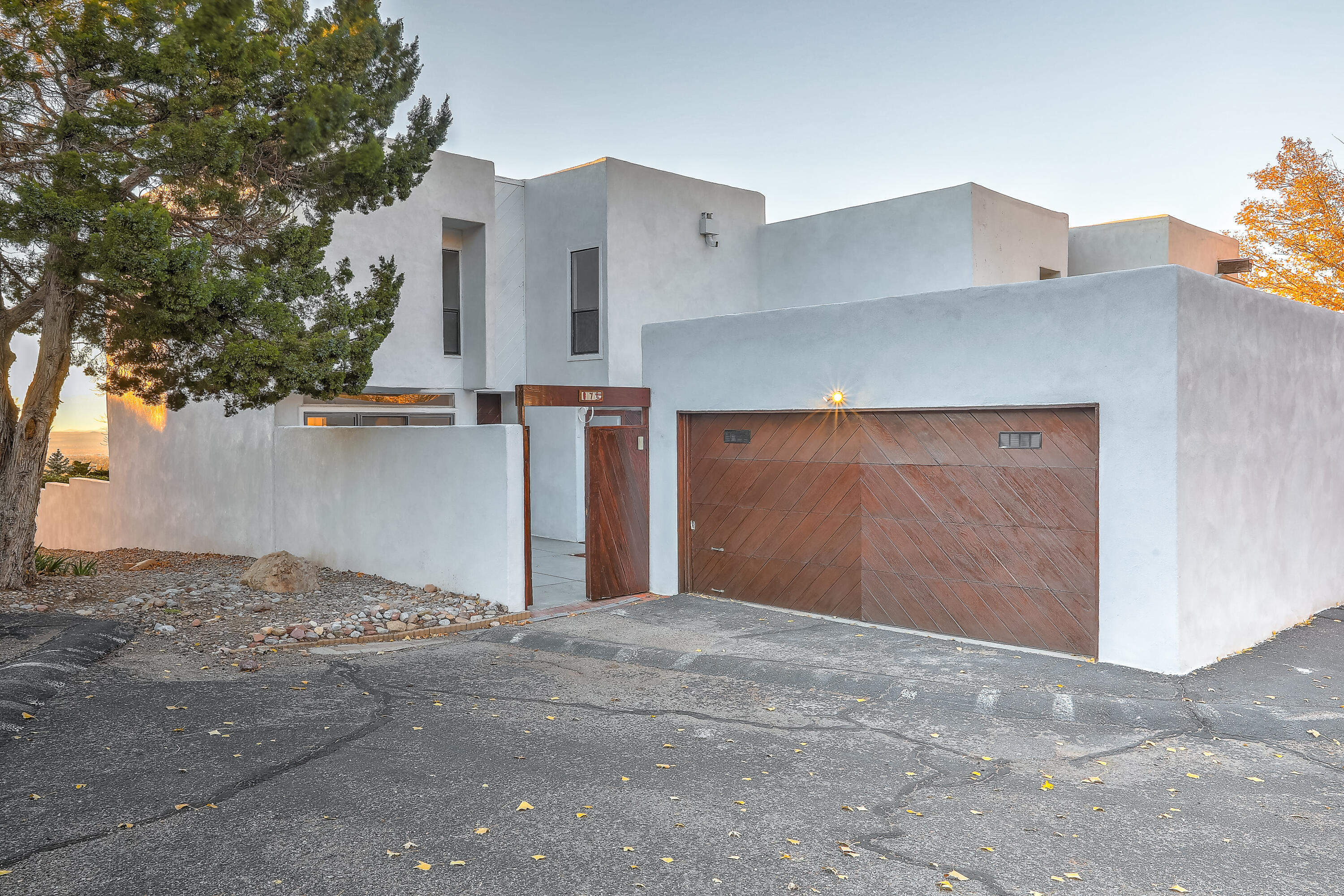 Luxury townhome nestled near the ABQ foothills! Boasting 4 spacious bedrooms plus a dedicated office, this home blends timeless architectural charm with modern updates including new flooring, paint, bathroom tile, some vanities, light fixtures and more. Enjoy breathtaking city and mountain views from the comfort of your home. The kitchen features new cabinets, butcher block countertops, and new SS appliances. The unique floor plan is great for many living situations, offering a perfect mix of character and functionality, great for entertaining including a cozy fireplace that adds to the home's charm. The owner thoughtfully preserved many of the original architectural details, making this home truly special. Call for a showing today!