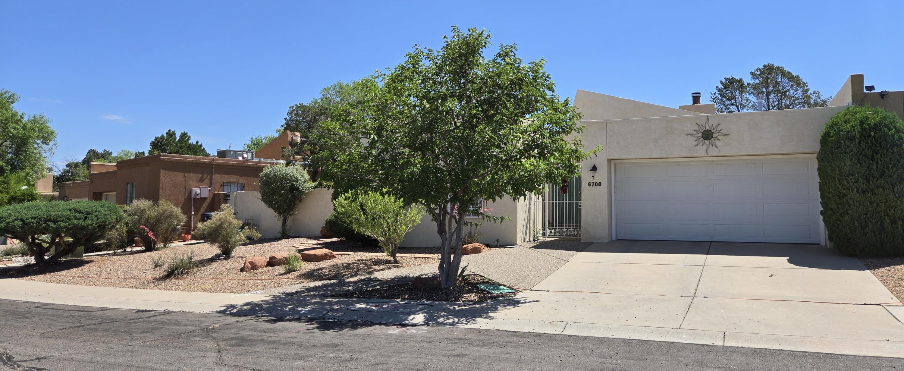 Walk in feel instantly at peace. Such an attractive, comfortable, spacious nest. Mossman built 2/2 townhome, 2 car gar, NO HOA. Only connected by the garage. Windows on all sides! Vaulted ceiling in the living/dining rm w/ a loft used to access roof for sunsets & star gazing. Living rm has a wood burning FP, slider to the yard. Updated kitchen has new appliances, breakfast bar & bonus bar/desk. Primary bedrm has space for any sized furniture, bathroom is roomy with 2 closets, sep tub/shower. Spare bedroom, full bath, storage closet are separate from primary. Thru the French doors are the private outdoor patios, colorful shaded areas to relax in. Low maintenance yards have a drip system, shrubs, trees, garden box.. plenty of room for pets to play. Many updates see list in docs. Must see!!