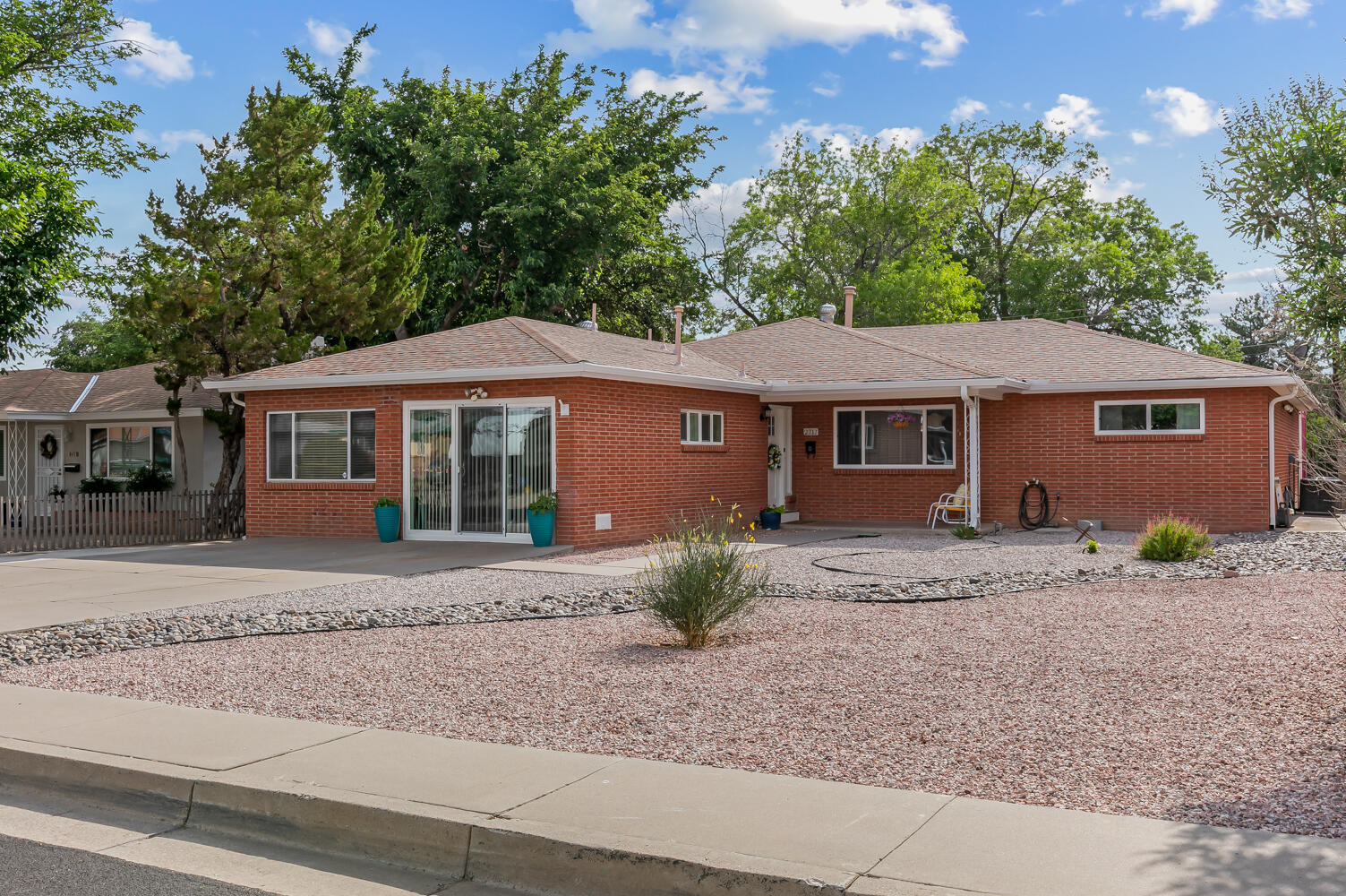 Wonderful single story home with in-law/guest suite in Uptown! This beautifully appointed property features: 2 living areas, NO carpet, Covered front patio w/ mountain views, Refrigerated air, Gorgeous wood floors, Designer light fixtures, Chef's kitchen w/ granite countertops, tons of counter space & custom bar w/ seating, Large primary suite w/ huge walk in closet & en-suite bath, In-law/guest suite includes kitchenette, bathroom, seating area and it's own separate entrance, Large yard w/ great covered patio, storage shed & raised garden beds.  New since 2018: furnace/refrigerated air, tankless H20 heater, washer/dryer, microwave, oven, d/w & electrical panel.  Conveniently located near Coronado Mall, ABQ Uptown, Winrock and easy access to UNM. Don't miss this turn-key property!