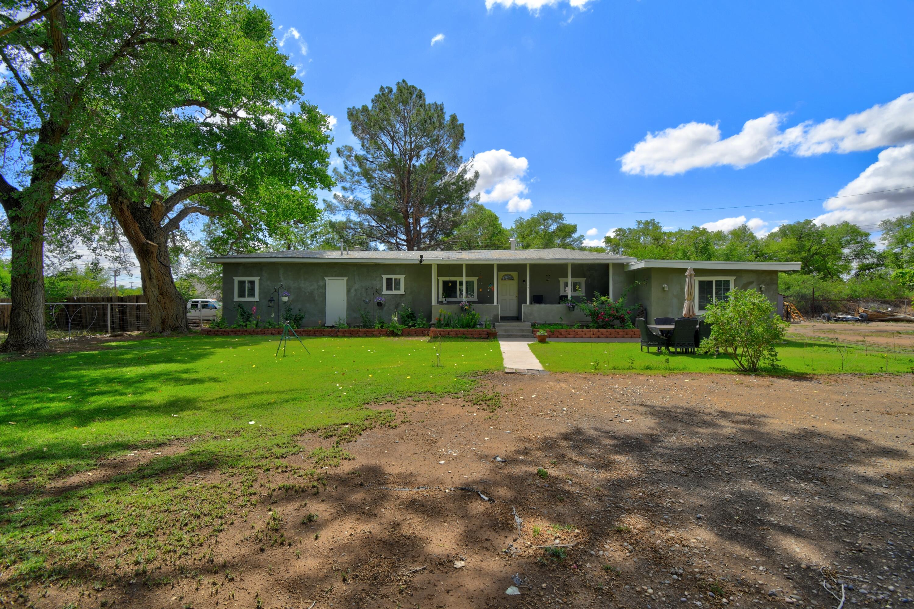 Quaint home in Los Lunas with mature trees and beautifully landscaped. Pride of ownership in this home with updated flooring, fresh paint and built in bar. The home stays nice and warm with the pellet stove in the heart of the home. Nestled on a half an acre lot with fruit trees and space for gardening. Room to add a work shop or garage.