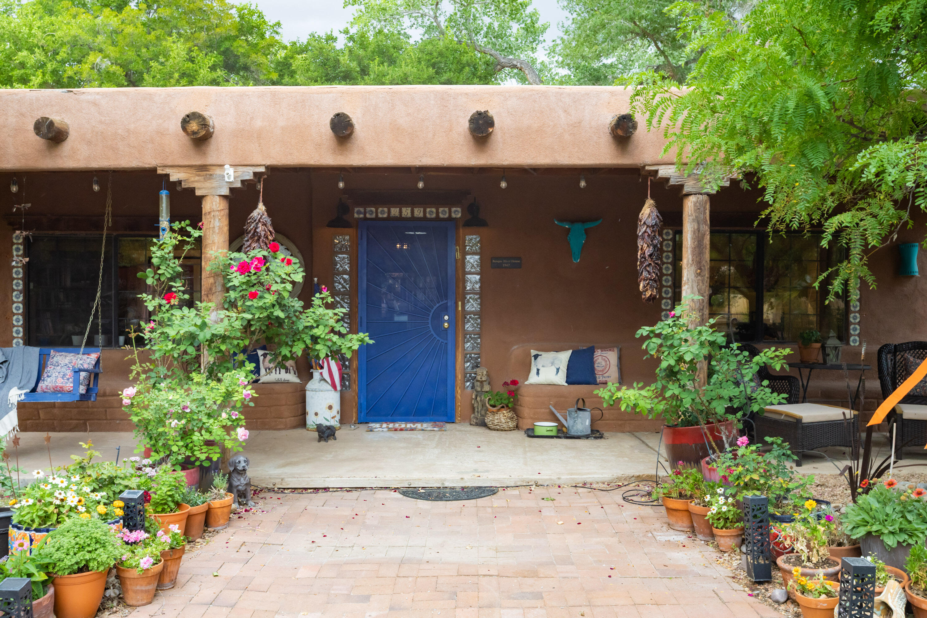 Rare opportunity in the South Valley.  Authentic, predominately adobe home on almost an acre near the Bosque! Land connects to the Atrisco lateral & horses are allowed. It is also just across the street from the Bosque & the Rio Grande.  Front of the property is a young orchard with apple, peach, cherry & quince trees. Charming home has many Southwest details including Talavera tile, kiva fireplaces & exposed adobe walls. Kitchen has a large pantry, butcherblock tops, a farm sink &  stainless appliances. Primary Suite has its own fireplace, built in bookcases, doors to the courtyard  & recently updated bathroom w/ separate shower & freestanding tub.  New TPO roof  Oct. '24. Additional features-AC, a large, shaded rear courtyard w/ a water feature plus land ready for garden or RV.