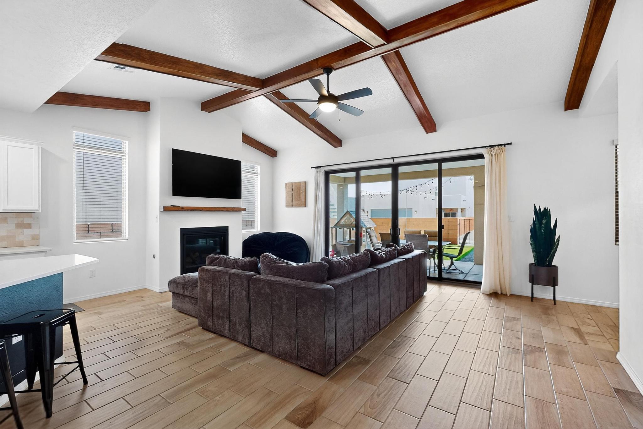 Impeccably Upgraded, and Full of Charm!This beautifully meticulous home is loaded with thoughtful upgrades and stylish finishes. Wood-look tile flows throughout the main living areas, complemented by boxed beams and a cozy fireplace. The gourmet kitchen stuns with white cabinets, upgraded white quartz countertops, and a modern open layout. A 12' x 8' sliding glass door brings in natural light and connects to the backyard. Other highlights include adult-height vanities, upgraded stairway handrail, and a laundry room with utility sink rough-in. Primary bedroom has a double sink and walk in closet. Located in a community with a pool and park, this home combines luxury, comfort, and thoughtful upgrades in every corner. It's the one you've been waiting for!
