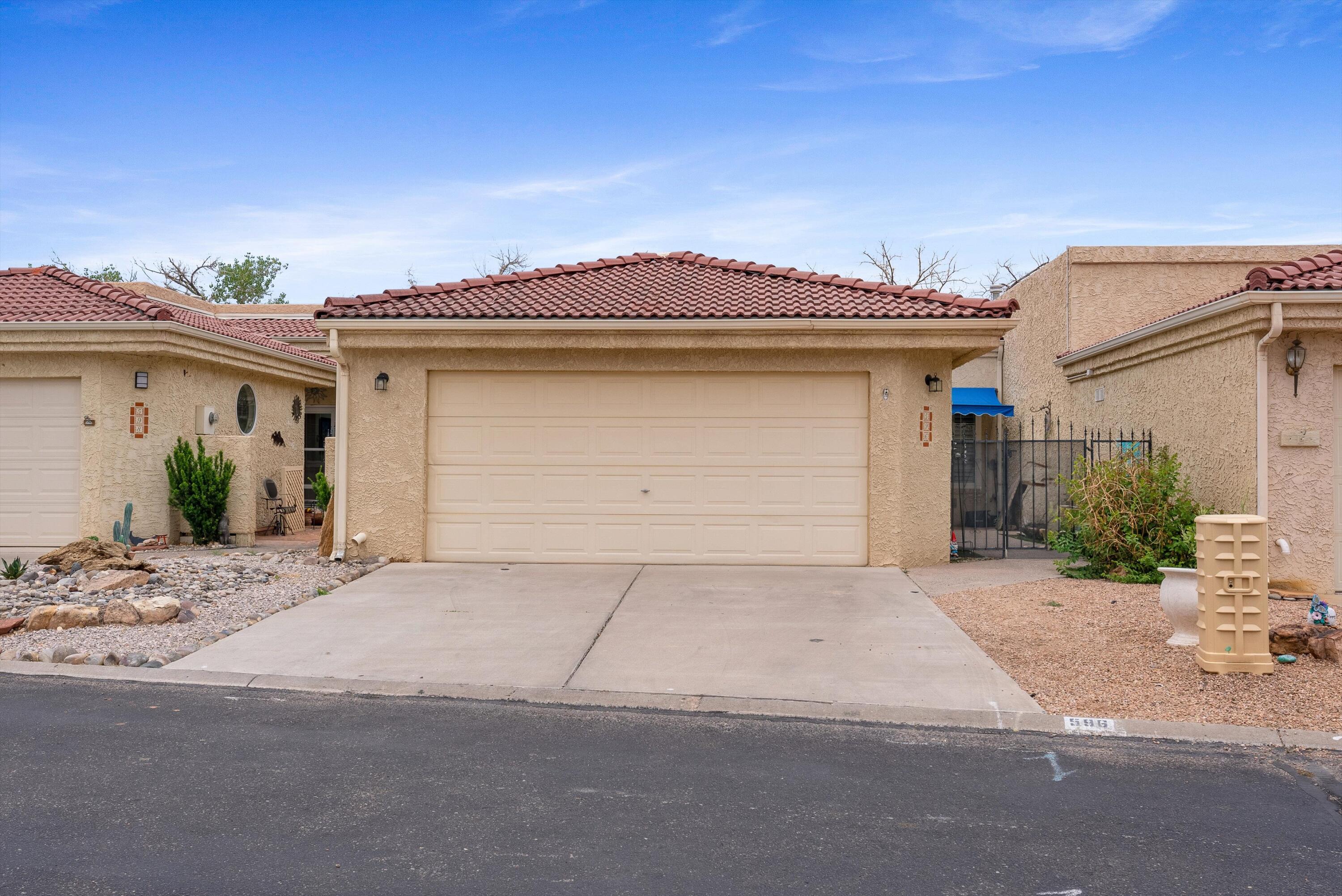 Beautifully updated 3-bedroom, 2-bath home in the desirable 55+ gated community of The Islands. Bright and inviting with fresh paint, newer flooring in bedrooms and a covered back patio area to enjoy quiet early mornings or lovely evenings watching the beautiful NM Sky! The kitchen features ample counter space, updated tile countertops. Living area offers a kiva fireplace, raised ceilings, and built-in nichos. Detached two-car garage and a gated courtyard / entry way.