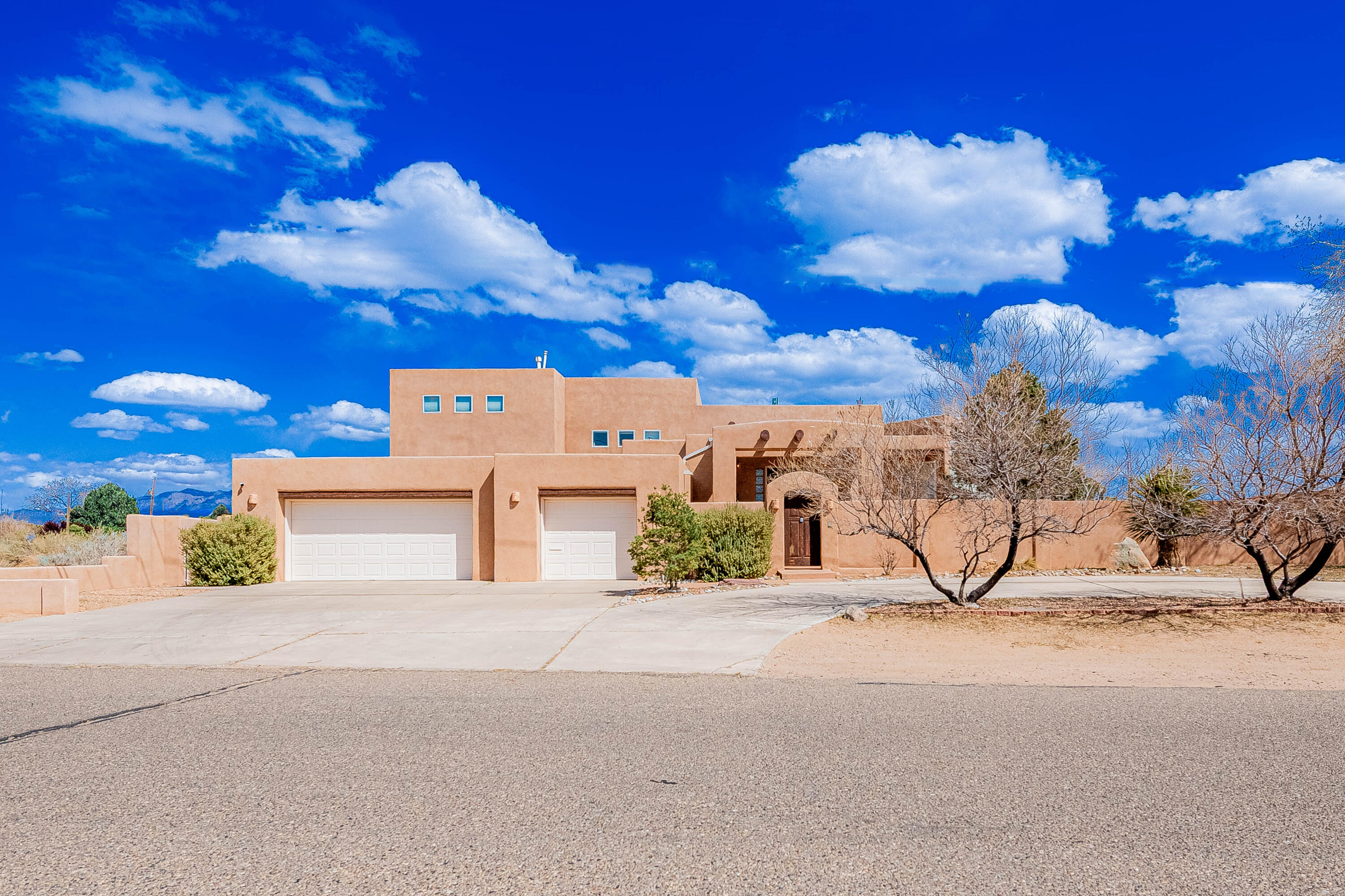 Welcome to Your Dream Home with Stunning City Views! Situated conveniently across from a park, this premier southwestern-style home is sure to captivate your senses. With elegant vigas and beamed ceilings. The unique tri-level floor plan offers a perfect blend of space and functionality. With a full-size master suite downstairs, to accommodate multi-generational living. Additional master suite on the upper level features a spacious walk-in closet, private balcony and a garden tub. Perfect for unwinding after a long day. The home boasts two living areas that provide ample space for family gatherings and entertaining guests. The chef ready kitchen is equipped with modern appliances and is perfect for culinary enthusiasts. Enjoy the sun rise over the Sandias on the back yard patio.