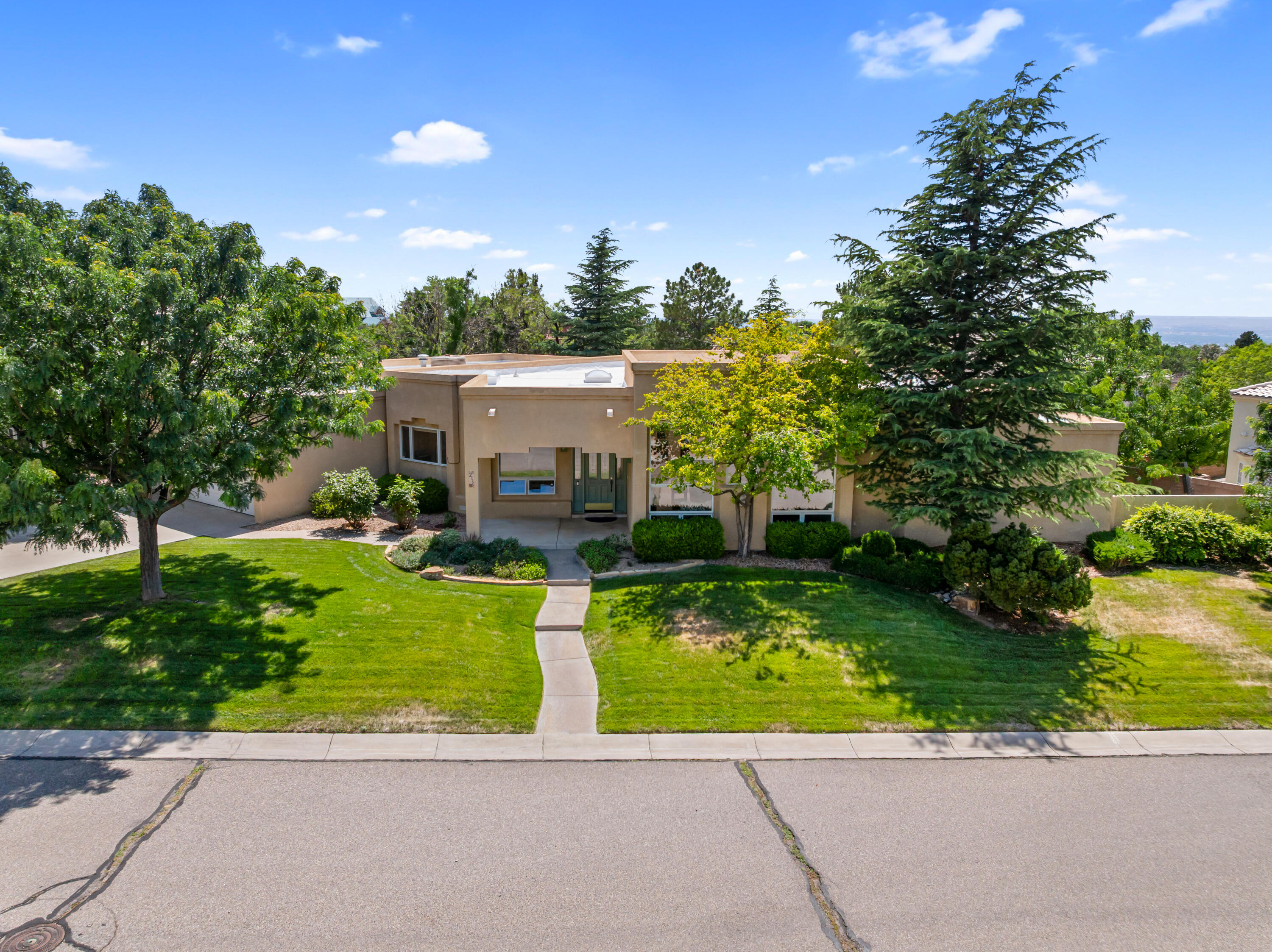 Breathtaking Mountain Views in Primrose Pointe! Enjoy panoramic Sandia Mountain views from your living room, breakfast nook, or even while washing dishes in this thoughtfully positioned single-story home. Designed to bring the outdoors and natural light in, this home features walls of Pella thermal/double-pane windows and doors, 11 skylights, and a serene private patio and backyard. The smart floor plan separates the spacious primary suite from a three-bedroom wing--ideal for guests, roommates, or multigenerational living. The gourmet kitchen is the heart of the home, complete with a large eat-in island, granite counters, stainless steel appliances, and abundant storage. With a new roof, updated mechanicals, and fresh skylights, all that's left to do is move in and soak up the views!