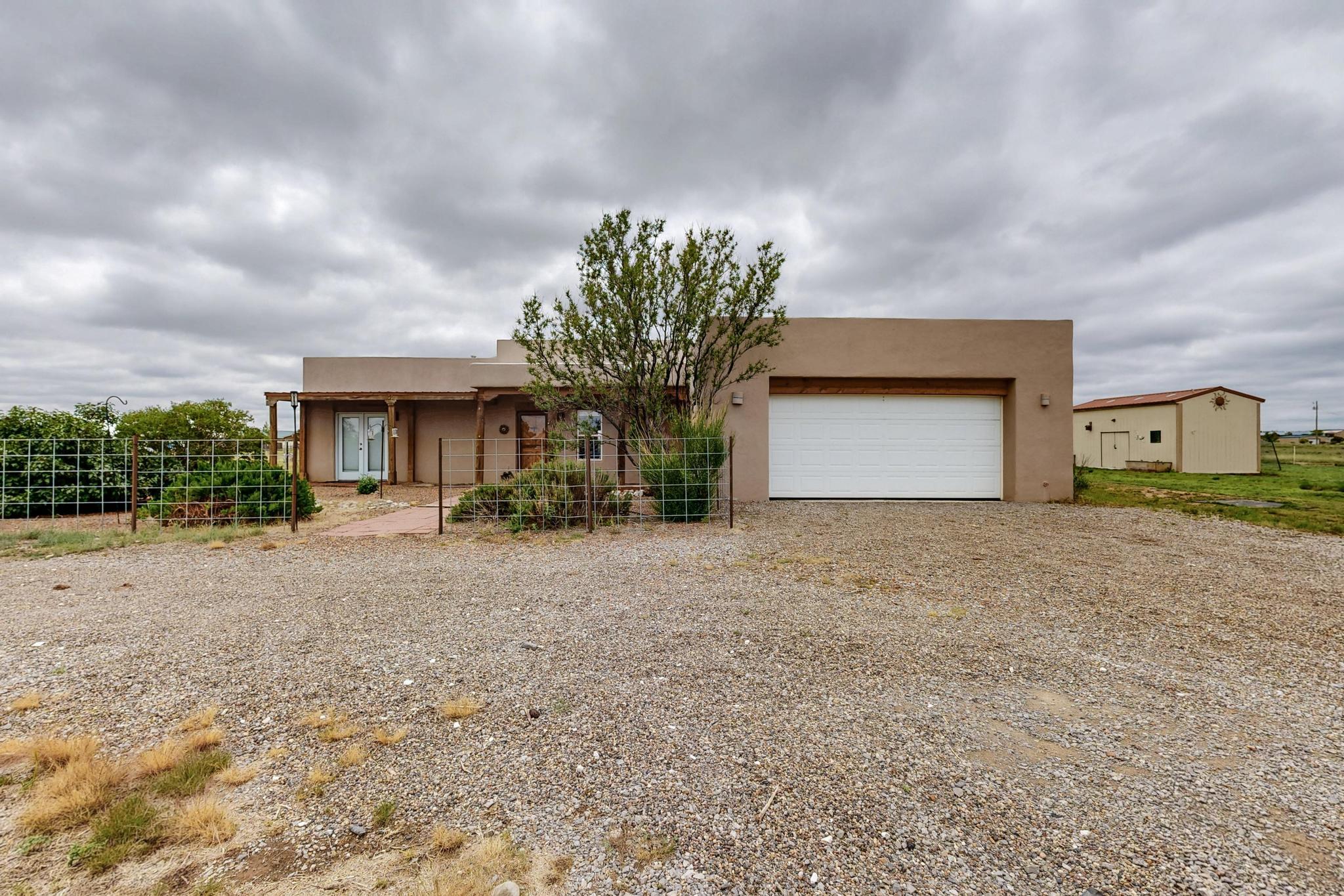 This custom built 3 bed 2 bath Rammed Earth Adobe Home is a horse enthusiast's dream! The southwest charm offers beautiful vigas and tongue and groove ceilings. The home boasts a well-designed floor plan, featuring a cozy living area with wood stove that seamlessly flows into the dining and kitchen spaces, creating an inviting atmosphere for gatherings. A dedicated office allows ability to work from home. The primary bedroom offers a private retreat with an en-suite bathroom and two closets.Situated on a generous 5-acre lot, the property provides ample space for outdoor activities, gardening, and potential expansion. New well, TPO roof, stuccoed parapets, PEX plumbing, and flooring completed in the last 2 years.The home offers a perfect blend of comfort and country charm!