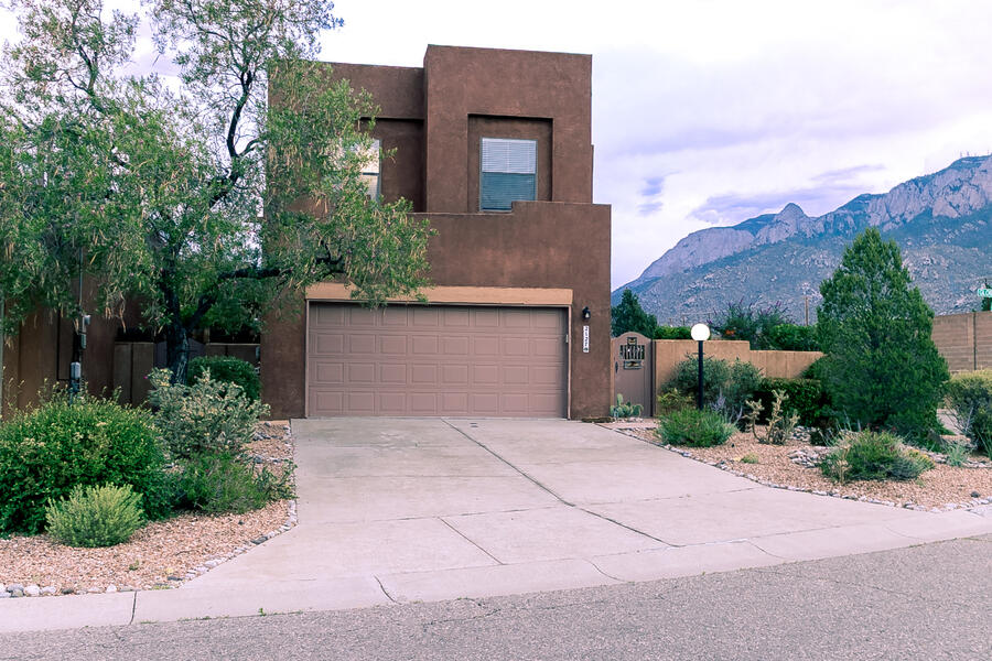 Custom Centex home in Sandia Heights. This two story home offers views of the Sandia's during the day and beautiful sunsets in the evenings. Two master suites , one with fireplace and oversized master bath. The other master can be turned into the 3rd bedroom. Loft is open and bright with views, Perfect at home office or second living area.  Main floor has breakfast nook, eat at counter and open to living room. One of the larger homes in this small private sub division.  Move in ready.
