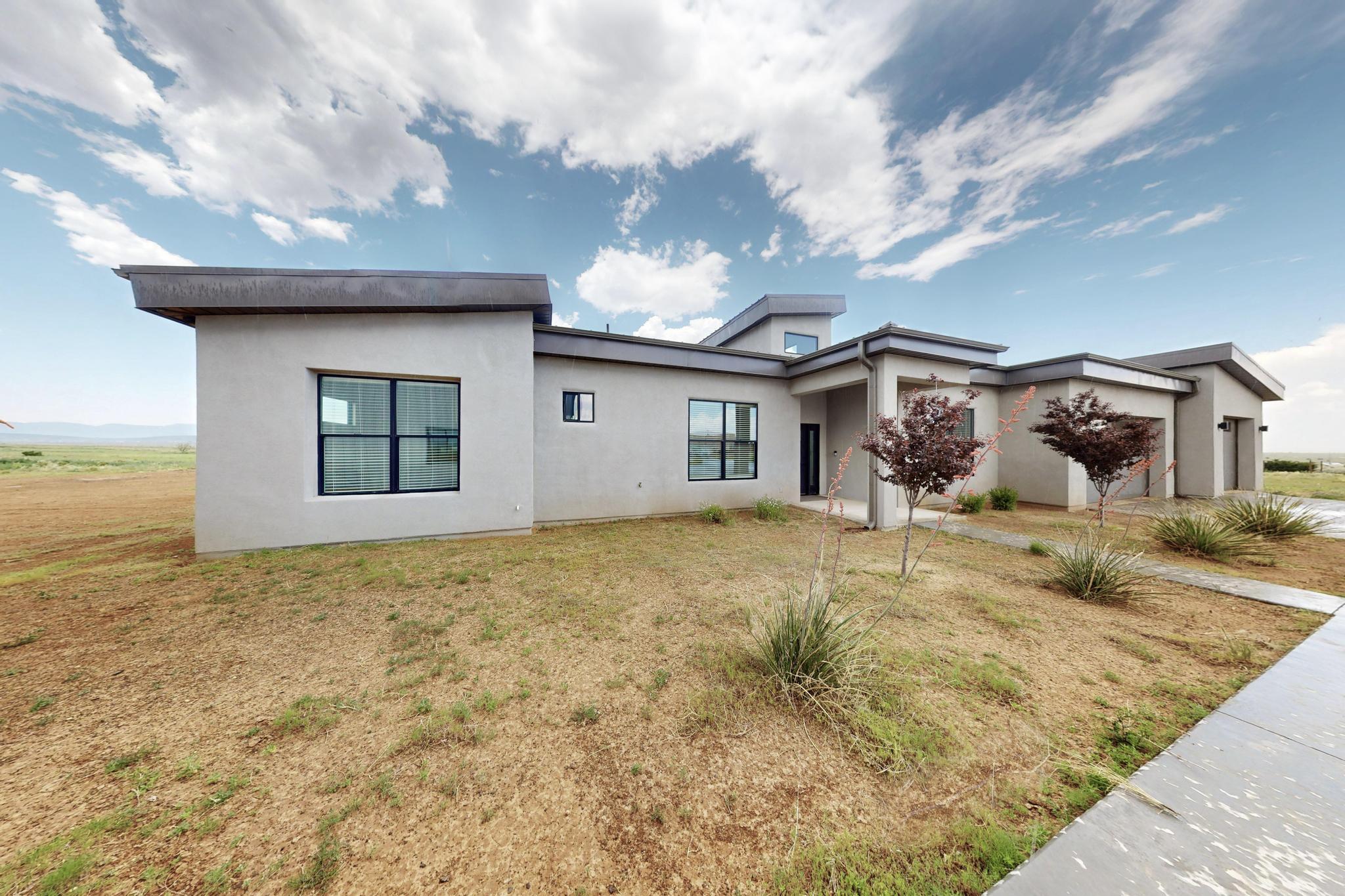 The breathtaking vistas of the majestic mountains, coupled with the sight of the airplane runway, offer a striking contrast that captivates the senses. This harmonious blend provides a truly remarkable locale for those seeking solace or motivation. Natural light floods in, creating a warm and inviting atmosphere. The custom design is further elevated by tall ceilings, open floorplan & seamless details throughout.  Equipped with designer cabinets this kitchen boasts plenty of storage w/ soft-close doors and drawers as well as 42'' uppers. In addition, two sinks allow for efficient meal preparation and cleanup. A pot filler is conveniently installed above the 48'' stove. Quartz countertops are throughout the home, providing both elegance and functionality.