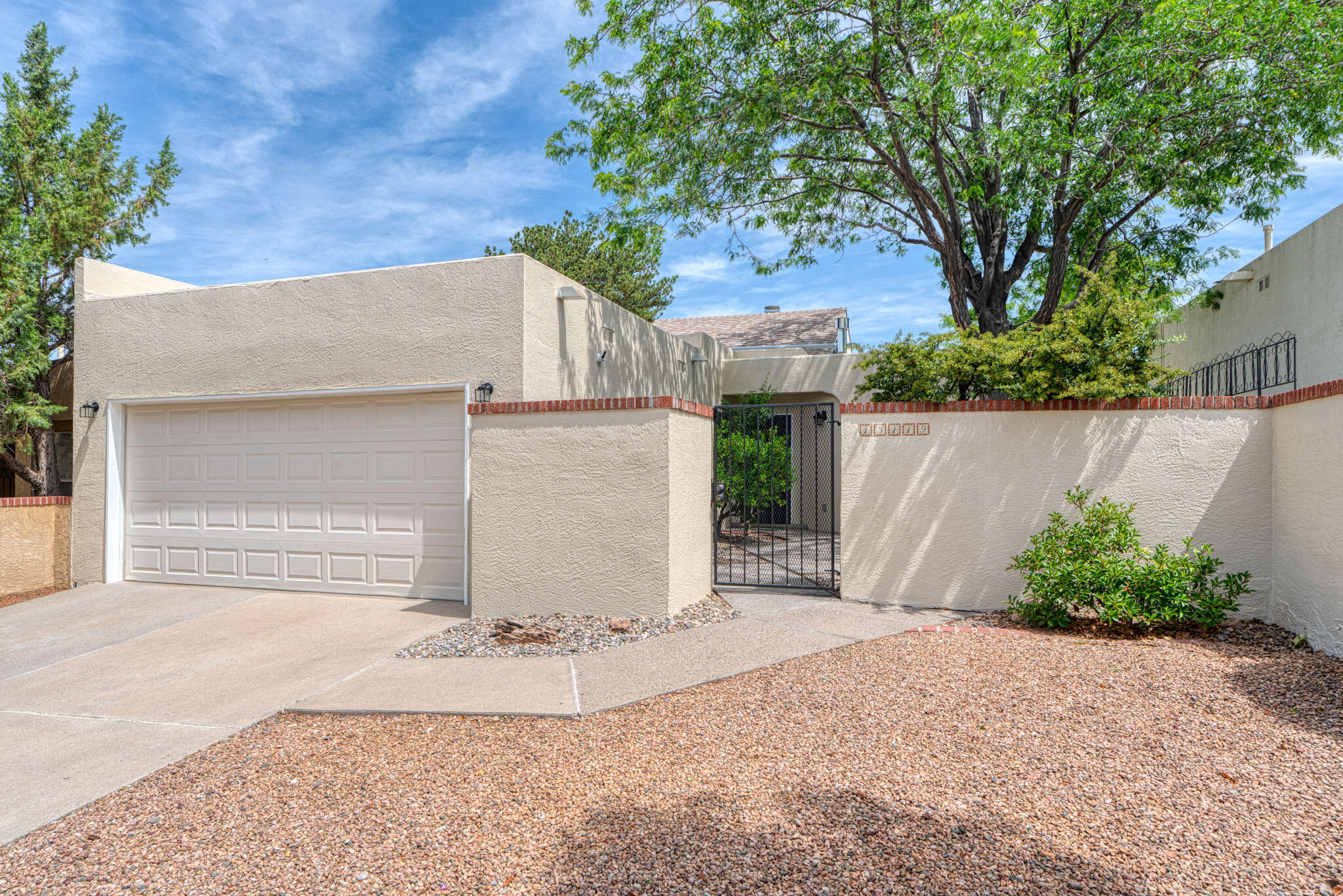 Love to hike the Sandias? Want a quick hop to the interstate? This foothills townhome in excellent condition is available for a new owner! Well-planned 2 bed, 2 bath home has tons of natural light and soaring ceilings with many updates throughout. Landscaped front and back yards w/ Sandia Mountain views in the back and shade trees in the front add outdoor living space. Big ticket items have already been completed - additional updates include: NEW primary bath shower, 2nd bath tub, surround & fixtures, fresh elastomeric stucco paint 2025, TPO roof 2024 (w/transferrable 20-yr. warranty), WH expansion tank/drain pan/valve 2021, refrigerated HVAC 2020...the list goes on! Highly desirable location in a quiet foothills neighborhood with NO HOA!
