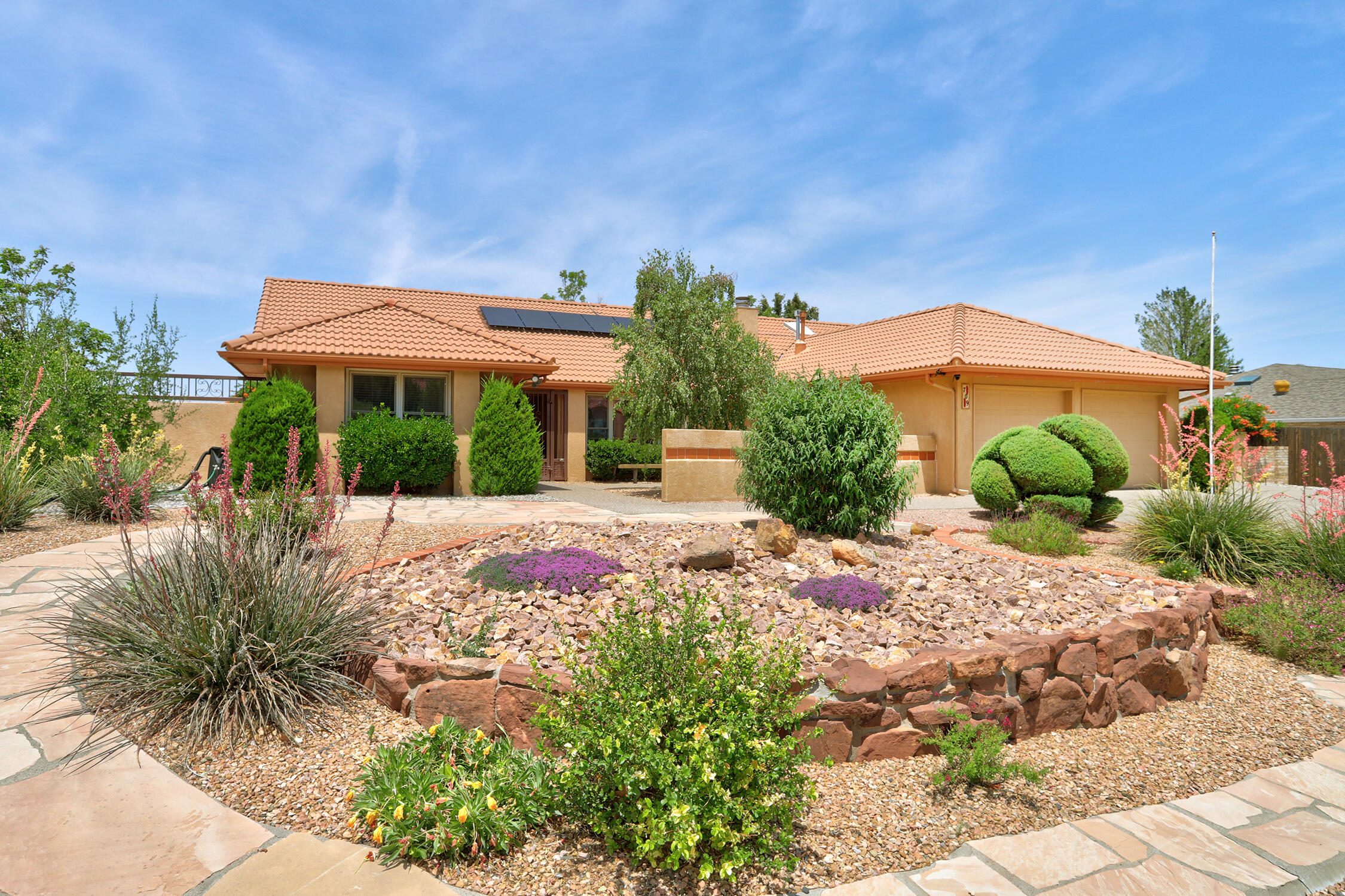 Beautiful single-story home backing to open space with stunning views in Four Hills! Bright, open floor plan with double-door entry leading to a spacious great room with high ceilings and a fireplace. The kitchen offers ample cabinet and counter space, black stainless appliances, & a sunny breakfast nook. The private, separated primary suite features a dual-sink vanity, jetted tub, separate shower, & walk-in closet. Beautifully landscaped front and backyards with lush grass, mature trees, flowering plants, two large sheds, & a garden. Enjoy the outdoors from the covered patio overlooking open space. Full side-yard access with paved parking--perfect for an RV or vehicles. Owned solar and recently installed AC! Close to The Canyon Club, golf, Kirtland AFB, shopping, & trails. Move-in ready!
