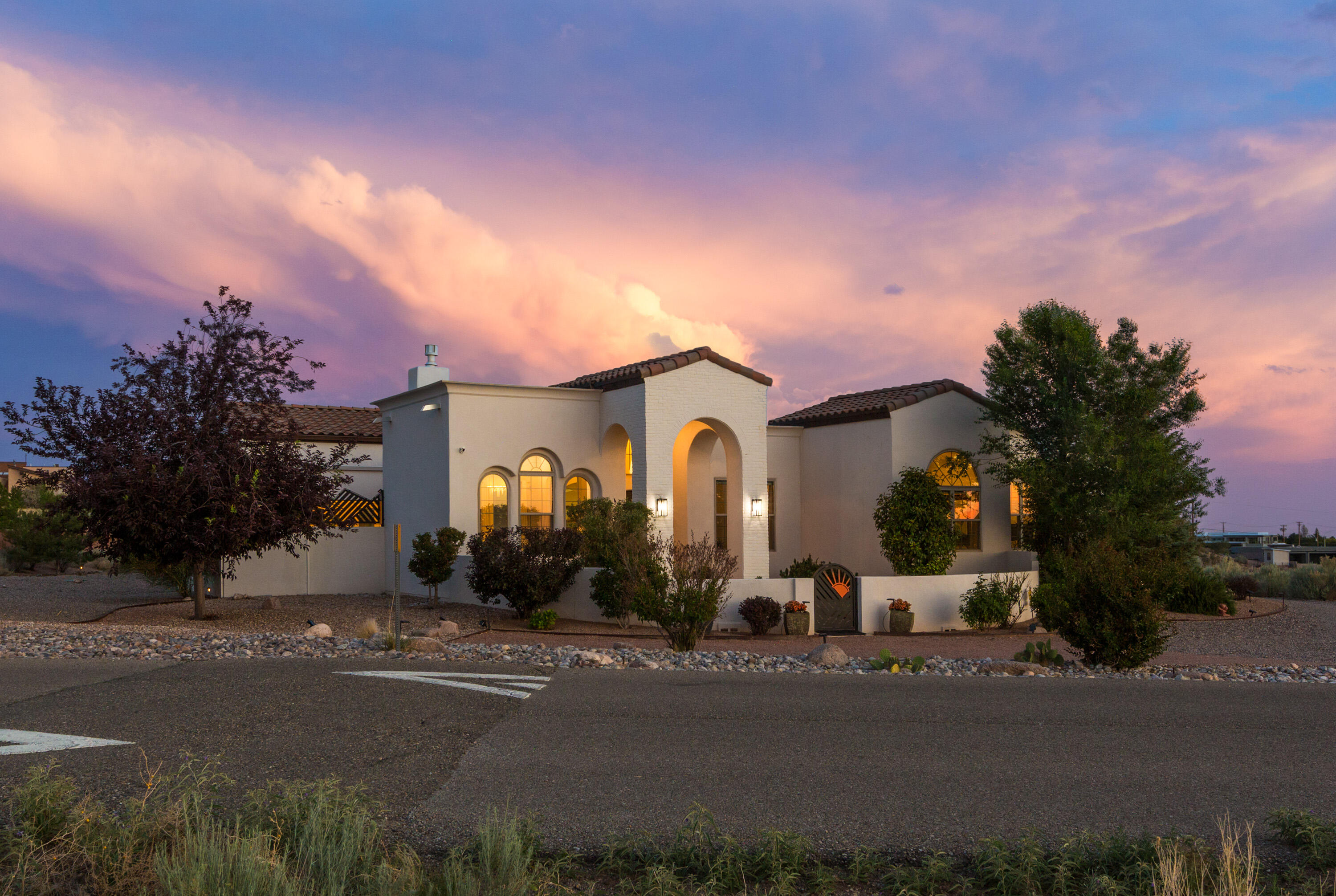 Experience timeless elegance in this stunning Spanish Revival home, where classic charm meets modern luxury. This beautifully crafted single-story residence features graceful arches, beamed and coffered ceilings, custom exterior gates, and inviting courtyards that blend indoor and outdoor living. Tall windows and exterior pocket doors fill the space with natural light. The kitchen boasts custom cabinetry, quartz countertops, and high-end stainless appliances. The spacious primary suite includes a flexible bonus area and a luxurious bath with marble flooring and countertops. Enjoy mountain views from the serene courtyard and peace of mind with a brand-new TPO roof under warranty.