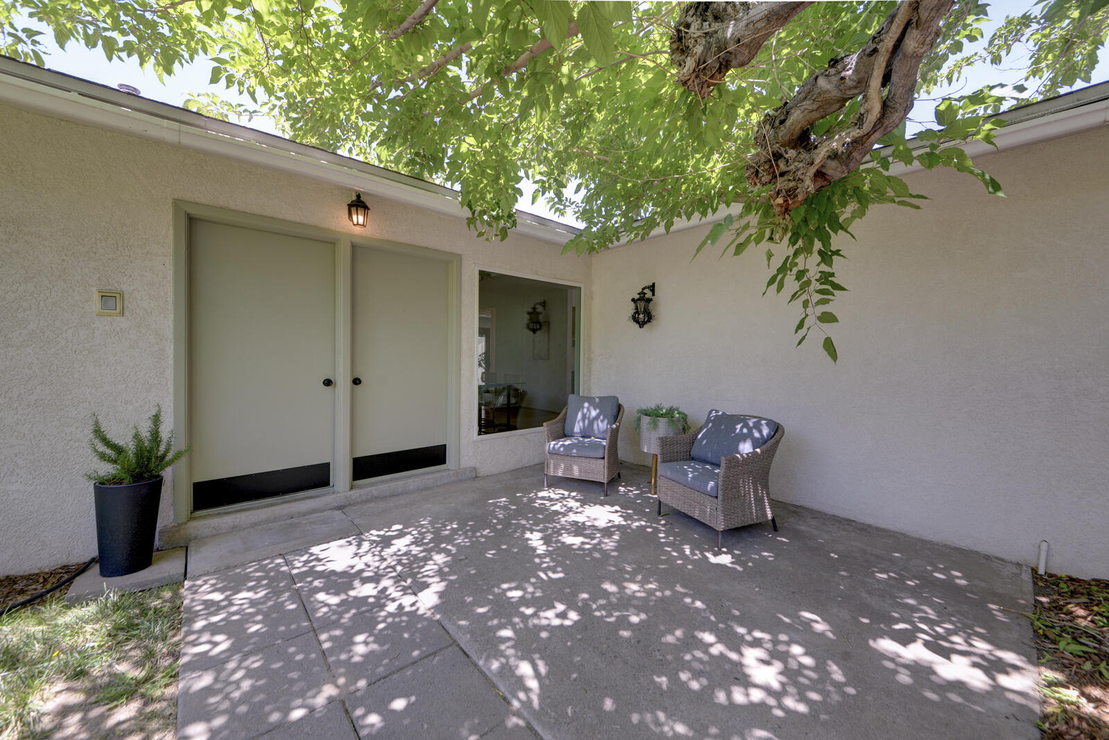 WOW! Delightfully charmimg NE Heights home - just what you have been dreaming about! Fabulous Large 834sf front courtyard with water feature & grass is the place you will love to be! Cool, private & inviting! This wonderful home offers great flexibility with living areas opening/looking to numerous outdoor spaces. The casual dining & kitchen flow together with large picture window overlooking courtyard.  Living room with vintage flair looks out to Pergola Portal featuring arches highlighting lush yard views. Family room makes great tv room, workspace or playroom & with French Doors to the .26 acre yard it will be enjoyed by all! Roof & Stucco new in 2018. Beat the heat w/central A/C!  Updated fixtures give home modern feel. Just painted + refreshed baths.  PBR opens to spa - hot tub room!