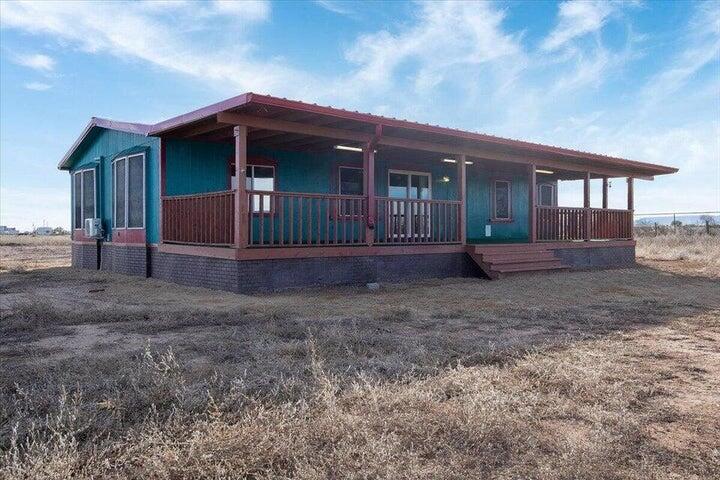 Beautiful 3 bedroom 2 bath manufactured home on 5 fully fenced acres. This house features tile, wood flooring, and carpet throughout, wood stove, multiple mini-split units for heating/AC that are less than 3 years old, and abundant natural lighting. Enjoy the views from a massive front deck! Property features a structure that could be used for shelter or hay storage, perfect for horses and critters of all kinds. Well was drilled in 2017 and septic system done in 2022. Come and make this claim your slice of the country living pie! Note some photos feature property vacant in 2023 as seller is conducting some cosmetic updates in the home.