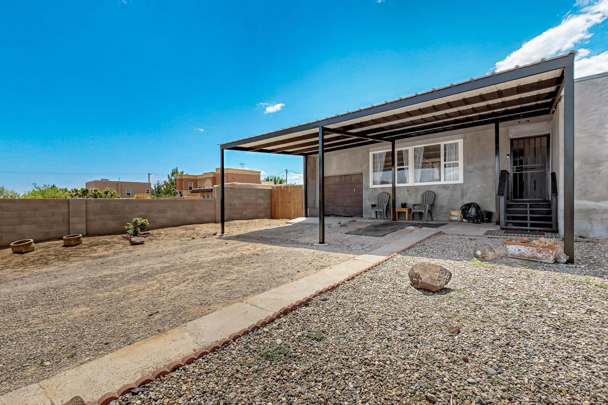 This move-in ready home sits on half an acre with backyard access, perfect for work trucks, RVs, or boats. Enjoy the convenience of stainless steel kitchen appliances and an LG washer and dryer, all of which convey. The microwave doubles as a second oven, and custom kitchen cabinets add charm and character throughout. You'll love the cozy breakfast nook with built-in storage and the 2025 upgrades, including fresh fencing and a new carport. Step outside to take in breathtaking Sandia Mountain views and stunning New Mexico sunsets from your spacious yard. The detached workshop is a dream! Complete with electrical, cooling, water, and attic space, making it easy to convert into a casita. Sellers are installing a new garage door, gutters and offering a $3,000 stucco paint allowance, so you