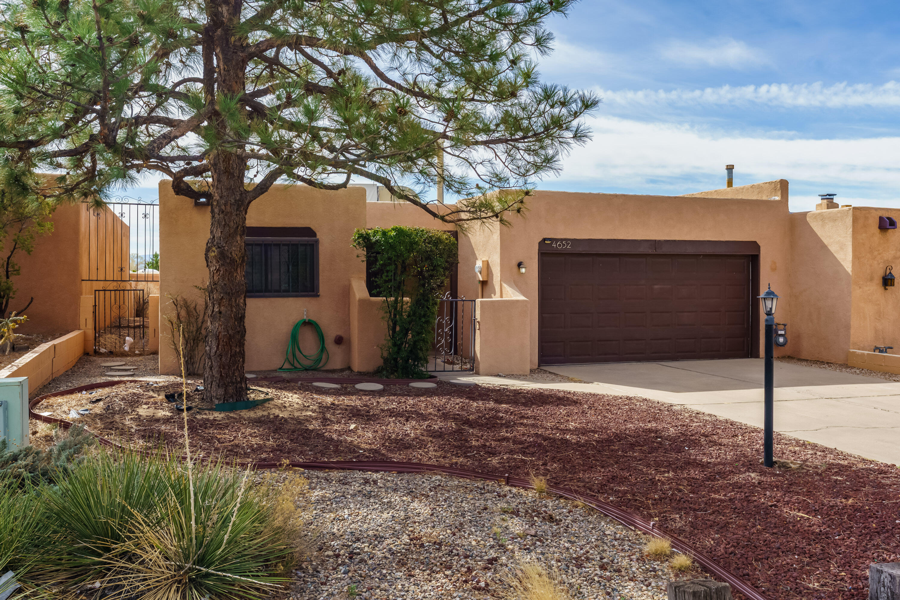 Brand new TPO roof! Welcome to this beautifully designed townhome offering 1600 sq feet of spacious, modern living. This 2 bedroom, 1.75 bathroom home features beautiful beam ceilings and a thoughtful layout, and is located in a highly desirable neighborhood with quick access to Paseo. The expansive open floor plan features a large living and dining room with a custom fireplace. Anderson doors lead directly to the private backyard, ideal for enjoying the outdoors while drinking your morning coffee, relaxing, or entertaining. Spacious primary suite features its own patio door, two closets, and a double sink. A brand new roof was installed just prior to relisting, offering peace of mind for years to come. Appliances that come with the house are less than 3 years old. You'll love this home!