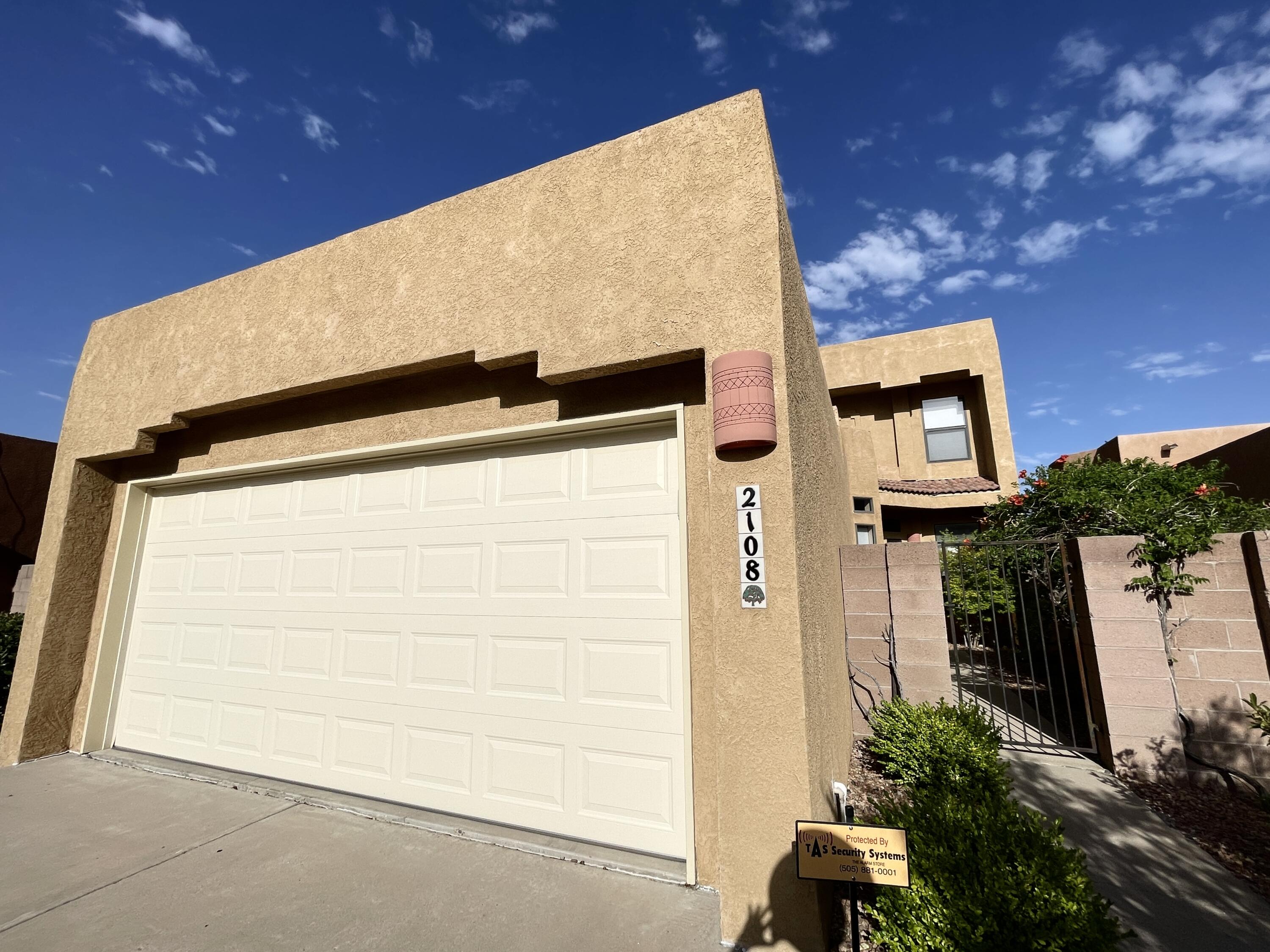 Lovely pueblo-style two story home nestled moments from the beautiful Sandias! Featuring an open floor plan and soaring ceilings, the great room boasts a gas fireplace and vaulted ceilings! The primary bedroom is on the lower level with a full ensuite with a garden tub, separate shower, and walk-in closet! The first floor also has a powder room and office/den that could be easily converted to a fourth bedroom! There are two spacious bedrooms and a full bathroom upstairs! The kitchen features granite countertops and an island, stainless appliances and an eat-in breakfast area. Enjoy the courtyard entry, private back patio & 2 car garage. New roof 2022. All appliances convey, no warranties. *Furniture and decor available for purchase*