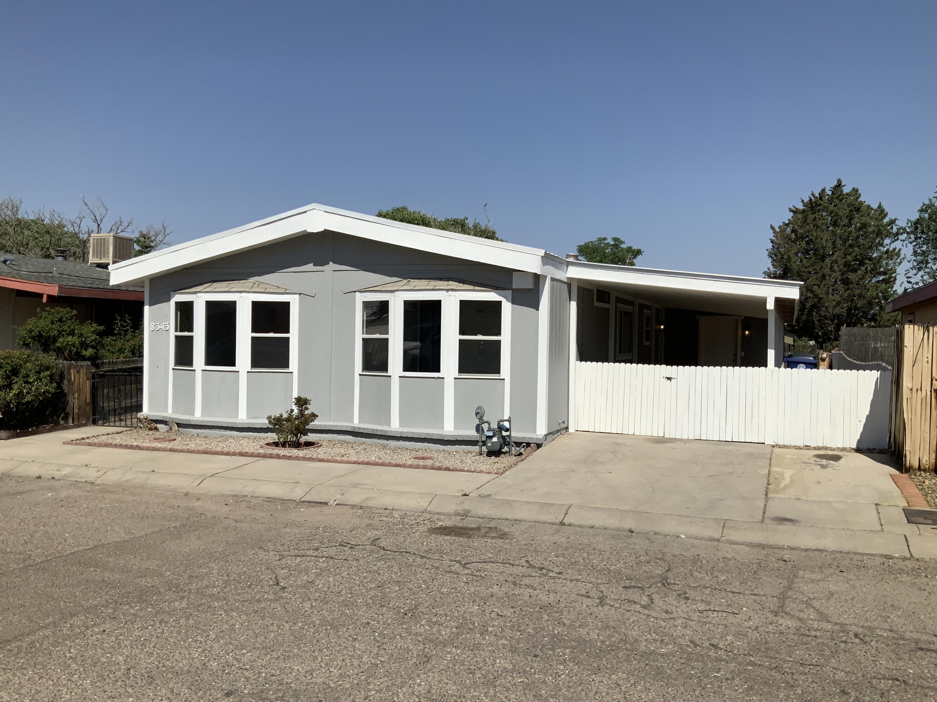Completely remodeled!  This is on land that you purchase, no space rent here!  Wait until you see this one...Metal roof, freshly painted inside and out, new kitchen cabinetry, quartz countertops, stainless appliances, fresh flooring throughout, fixtures, fans, toilets, vanities, hardware, furnace, exterior doors and so much more...HOA is $140 monthly and covers Pool, water, sewer, trash & neighborhood amenities.  Come take a look!