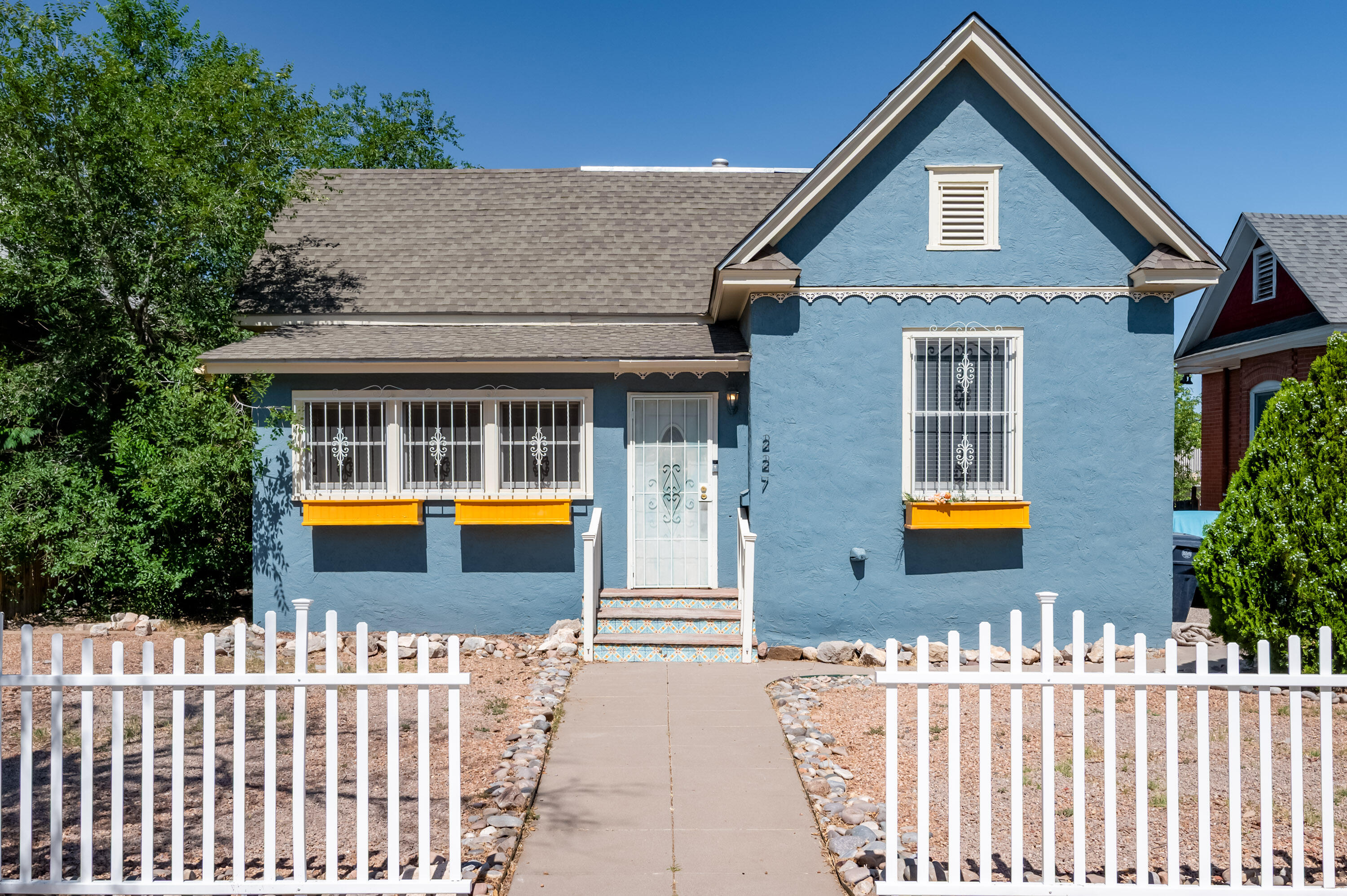 Welcome to this enchanting Victorian-style home nestled in the sought-after Huning Highland District, offering convenient access to Downtown amenities. Surrounded by a white picket fence, this home radiates curb appeal and timeless character. Inside, you'll find 3 bedrooms, 2 bathrooms, and a layout full of warmth and possibility. Natural light pours in through large windows, highlighting the architectural detail and raised ceilings provide room to breath. In addition to the main living spaces, the home features two enclosed patios--perfect for hobby rooms, home offices, or personal gyms. The spacious lot offers ample parking in the back, and with R-ML zoning, there's potential to build a second home for income-generating use or multigenerational living. You don't want to miss this one.