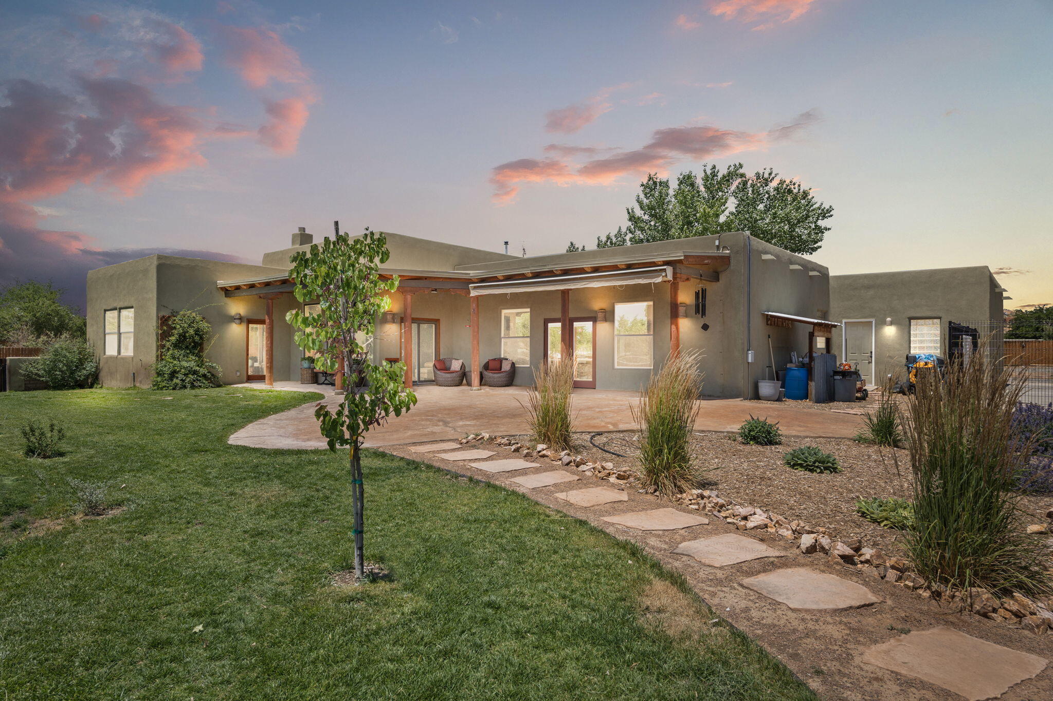 Serenity and country quiet await you in this beautifully upgraded Corrales home! Expansive windows frame stunning Sandia Mountain views and fill the home with natural light. Enjoy peace of mind with new silicone roofing (2024), paid-off 6.67kW solar system, remodeled 1/2 bath, professional landscaping, recent paint and fencing, and a solar-powered front gate. Located on a cul-de-sac for added privacy, the property offers an appealing split floor plan plus RV/boat parking and zoned irrigation for lush lawn, trees, and bushes. Entertain with ease on the spacious covered patio with auto-retractable awning. Beyond the property, embrace the Corrales lifestyle--Bosque trails, acequia paths, wineries/restaurants, art galleries & the local farmers market. This isn't just a home--it's a way of life!