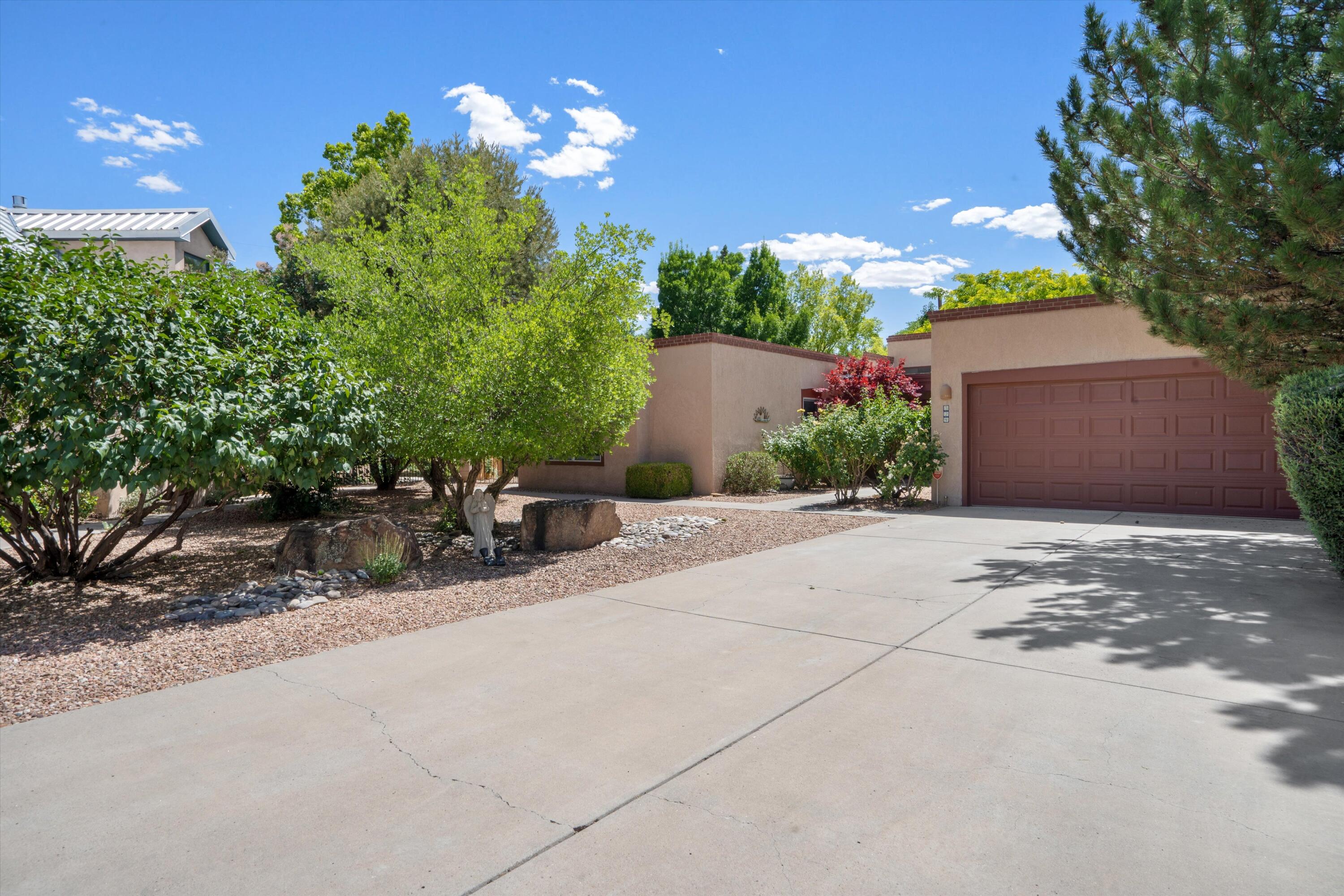 Welcome to 324 La Chamisal! Located in a quiet gated community in the heart of Los Ranchos, this charming 3-bedroom, 2-bath home blends Southwestern character with modern comfort. Step inside to find warm in-floor radiant heat, a cozy kiva fireplace, and a spacious layout perfect for both relaxing and entertaining. The large primary suite offers a peaceful retreat with a walk-in closet, double sinks, and a soaking tub with a separate shower. The kitchen features granite countertops and ample cabinetry. Outdoors, enjoy the beautifully landscaped front and backyard with mature trees and a full drip irrigation system. The covered patio ideal for outdoor living! This inviting home offers the perfect blend of privacy, charm, and convenience in a highly desirable location.
