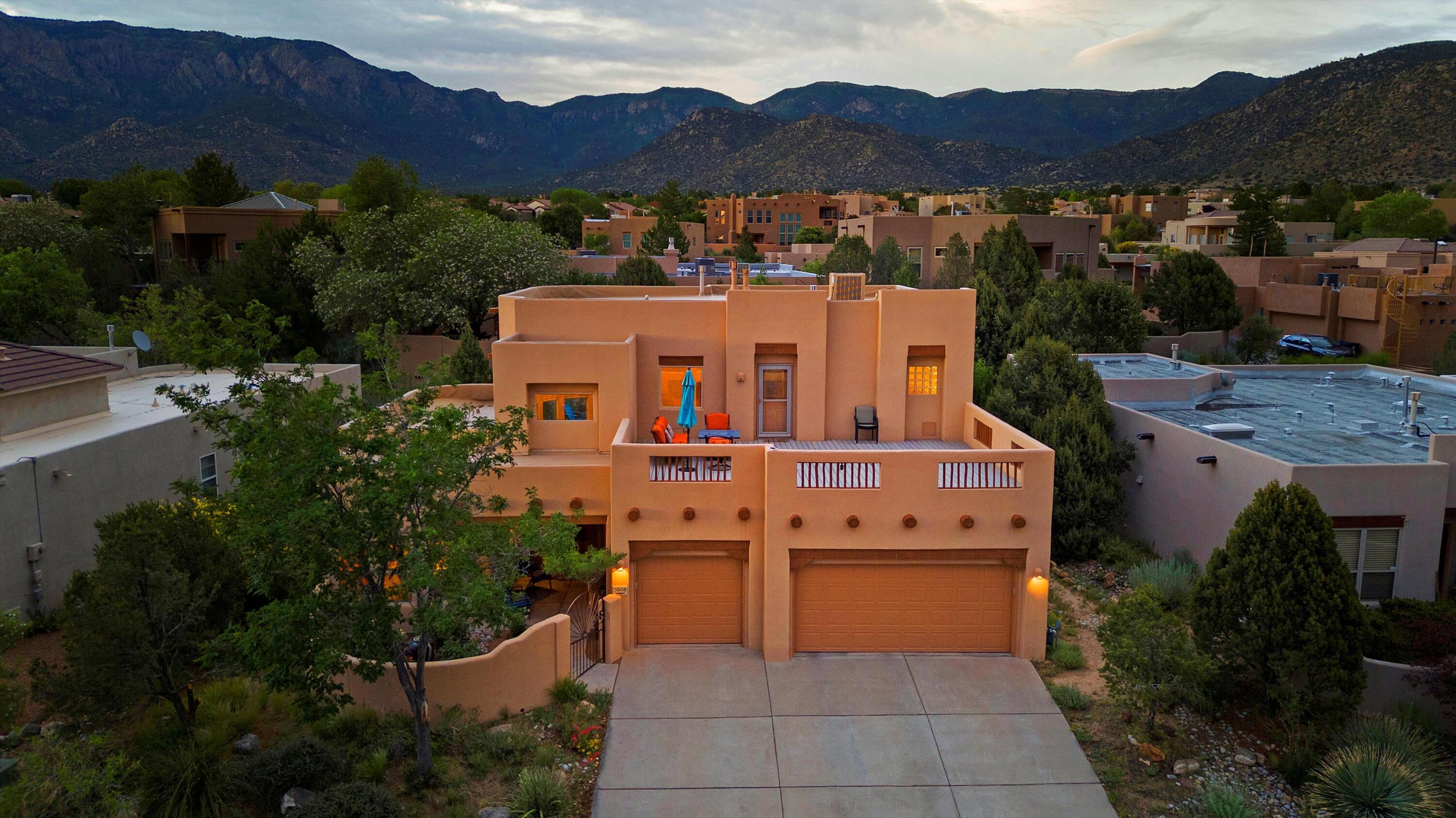 Tucked away on a no-through street, in the coveted Solterra at High Desert community, this serene sanctuary offers a rare blend of comfort and elegance. Passing through the peaceful courtyard into the home you are welcomed with Brazilian cherry wood floors, soaring cathedral ceilings, and a dramatic wall of windows that flood the living space with natural light. The entire top floor is dedicated to the comfort and enjoyment of the primary residents - with a spacious bedroom that includes a reading nook or office, a luxurious bath, and an organized closet space. Opposite the bedroom is a stunning balcony with mountain views and a peek of the city, ideal for sunrise coffee, intimate stargazing, or inviting friends up to watch fireworks or balloons.