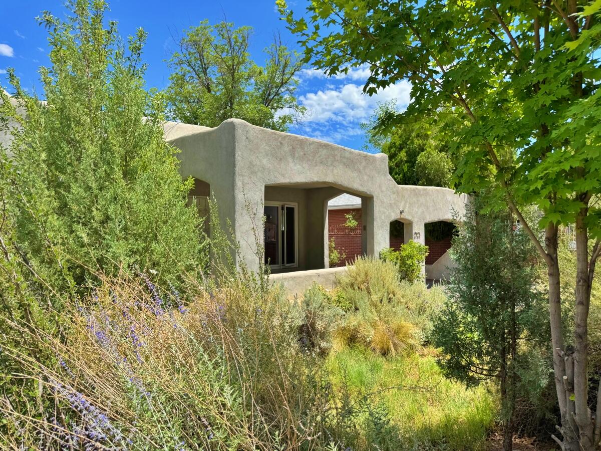 Silver Hill Gem! Quintessential 1920's adobe home on the Historic Register, complemented w/ modern upgrades. Start in the lush front yard & the large south-facing covered porch. Open House Sat 11-1pm! Inside, the gracious living room has tons of light & excellent wood fireplace centerpiece. Air-tight Pella windows & combo heat/cool system create cool summers indoors, & toasty winters. Kitchen features Bosch 5-burner cooktop range with powerful Fagor hood; quartz counters, stainless & Pennyround tile backsplash. See the 3D Tour! Plus, updated bathroom slip-resistant floor tile, bright solatube skylight & circular anti-fog vanity. More good news: Navien On-Demand, prime bedroom mini-split, 2'' rigid foam TPO roof. Excellent high-walled lush & private backyard chill space. Walk to UNM/CNM!