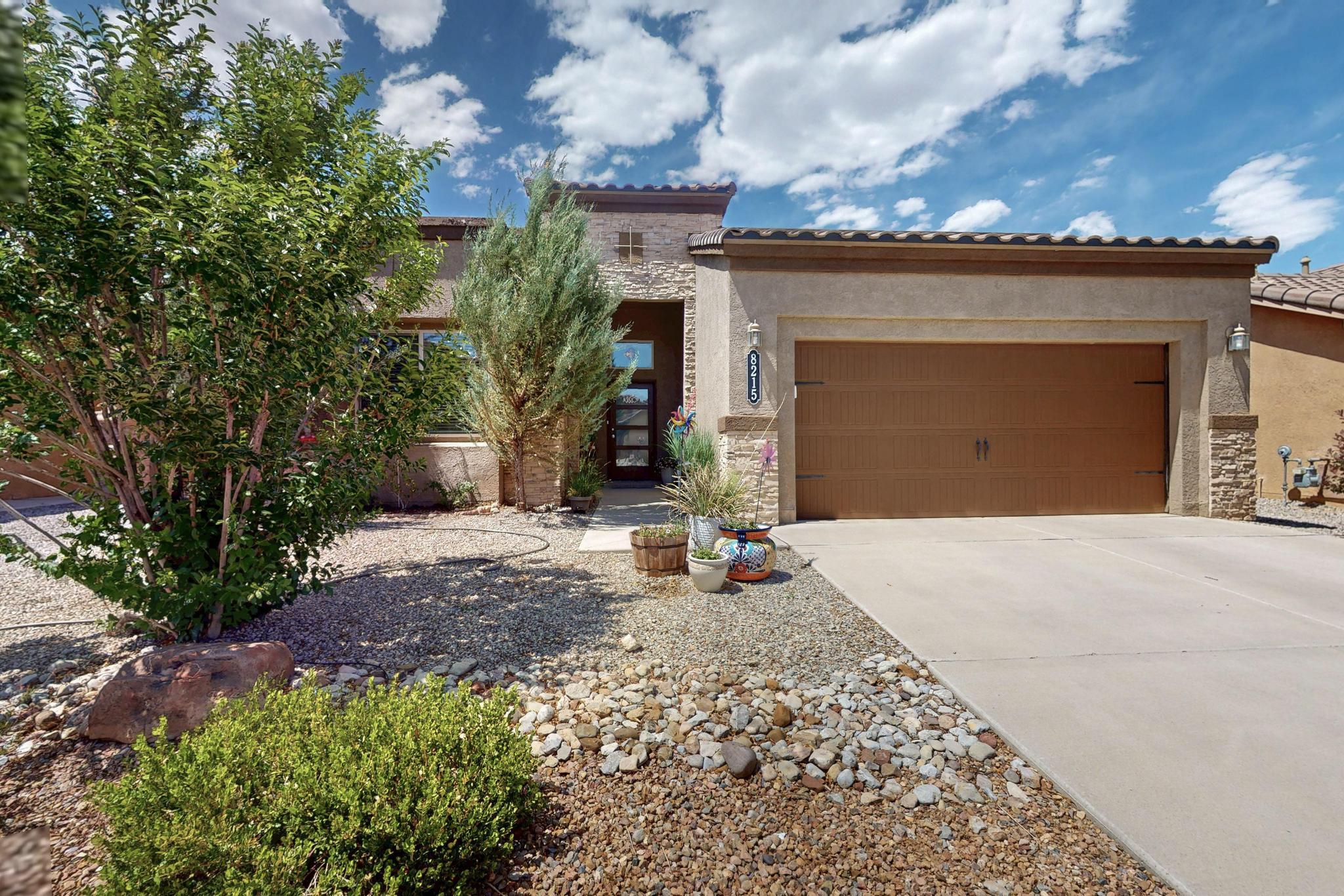 Welcome to 8215 Mock Heather Rd NW - where comfort & community come together!  The pride of ownership is obvious in this beautifully maintained home! It offers 3 bedrooms, 2 bathrooms & a spacious open-concept layout; perfect for everyday living & entertaining. The bright kitchen features ample counter space with gorgeous granite tops, SS appliances & a breakfast bar that flows into the inviting living area. The living area is spacious and bright with beautiful floors & a gas fireplace. A sunroom adds a perfect flex space! Enjoy a private owner's suite with a walk-in closet & ensuite bath. The backyard offers a huge patio surrounded by the perfect amount of greenery! Located Montecito Estates, residents enjoy exclusive access to a private community center & a sparkling swimming pool.