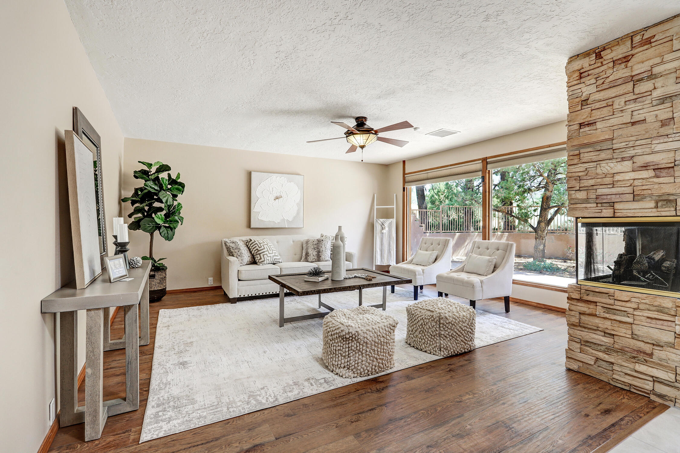 OPEN 6/21/25  1- 3 PM   Sandia Heights Stunner!  This home sits on just over an acre with mountain and city views. Flexible floor plan provides room for all  with TWO large primary suites (one up and one down) each w large closets and remodeled bathrooms, two more generously sized bedrooms with double closets on the main level. Three living spaces offer room to relax or entertain. Huge kitchen with brand new tile  and TONS of cabinet and counter space with a massive island, double WOLF ovens WOLF 5 burner cook top and a pot filler, stylish lighting and stone counter tops, & a sub zero fridge.  There is room for an eat in kitchen plus space for a larger dining table.  Detached casita includes a full bath and a wood burning fireplace.  Superb location with highly rated schools