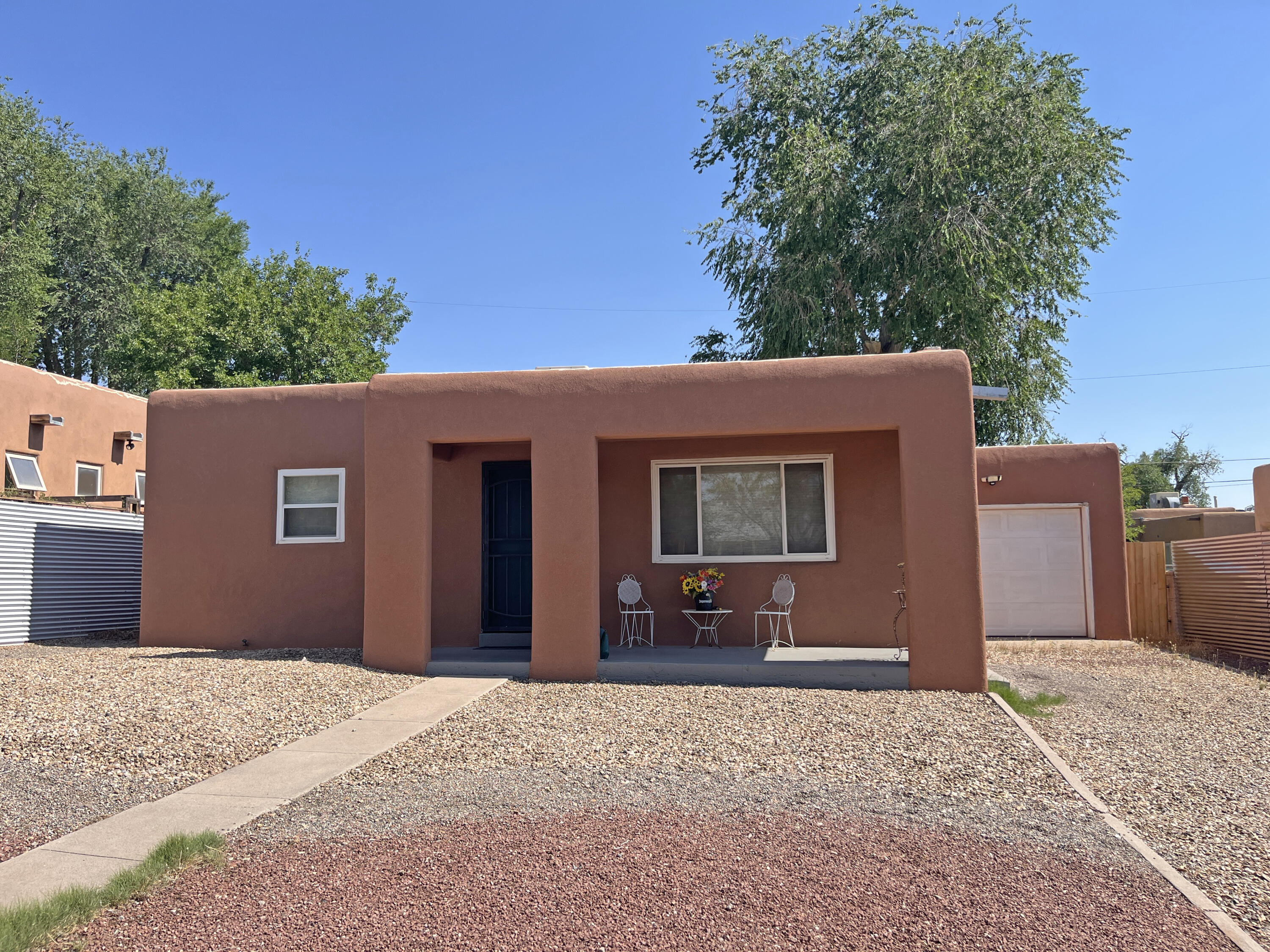 Charming house with hardwood floors.  Laundry room adjacent to kitchen with doors to backyard and garage. Washer, dryer, microwave and kitchen refrigerator stay. Easy care landscaping. Windows have been replaced. Quiet location with easy access to UNM, Sandia Base, Nob Hill and downtown